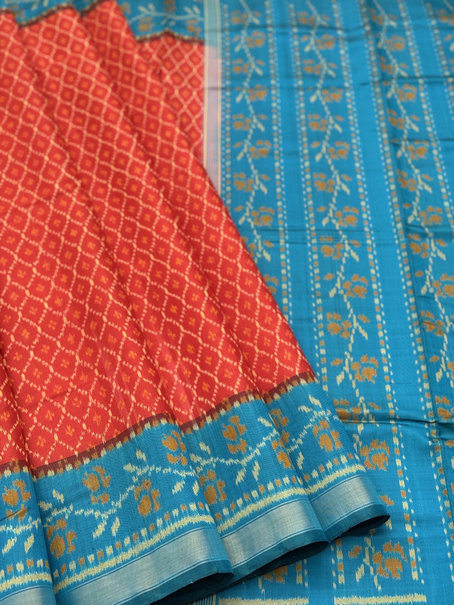 A gorgeous burnt Orange with teal single ikkat patola silk saree