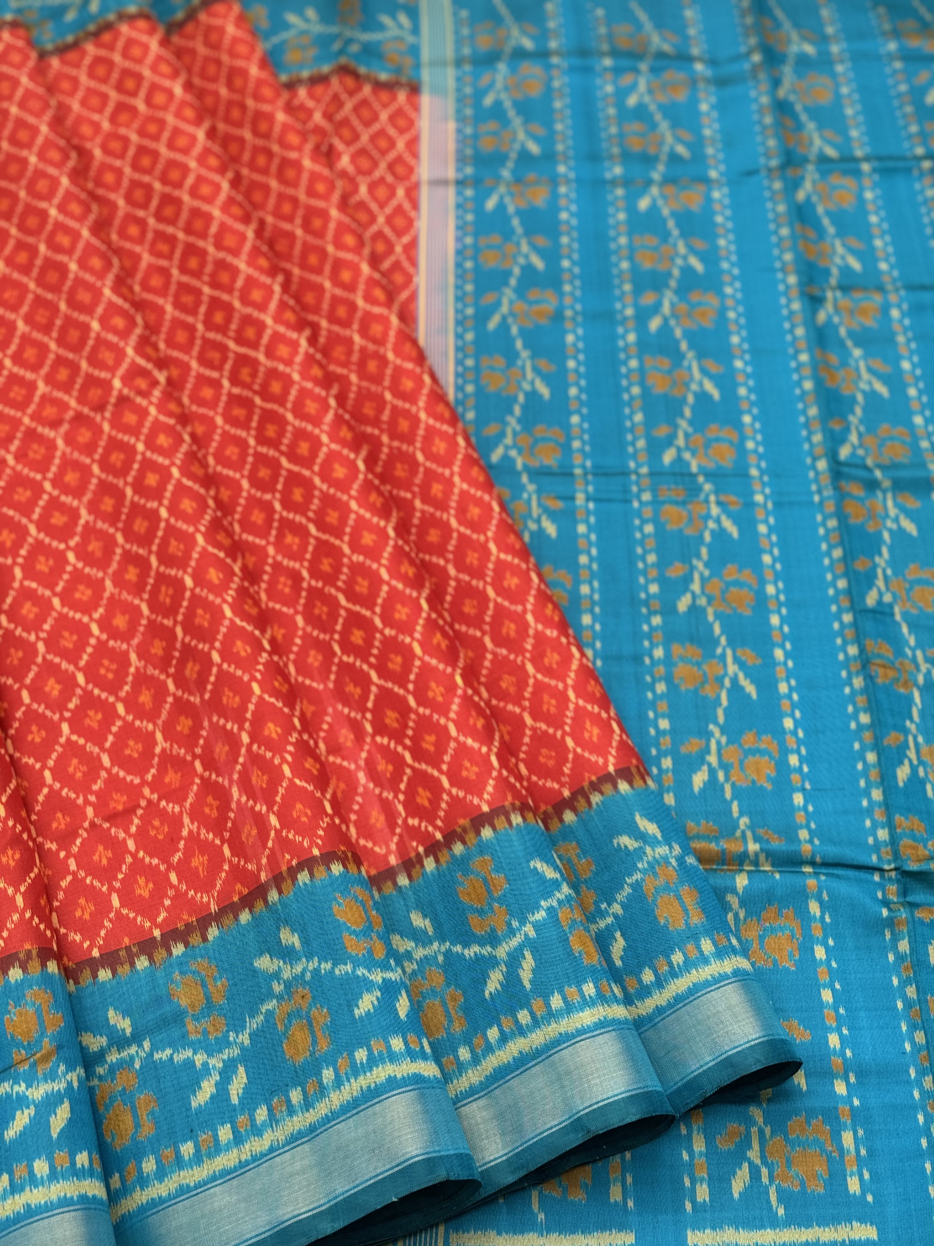 A gorgeous burnt Orange with teal single ikkat patola silk saree