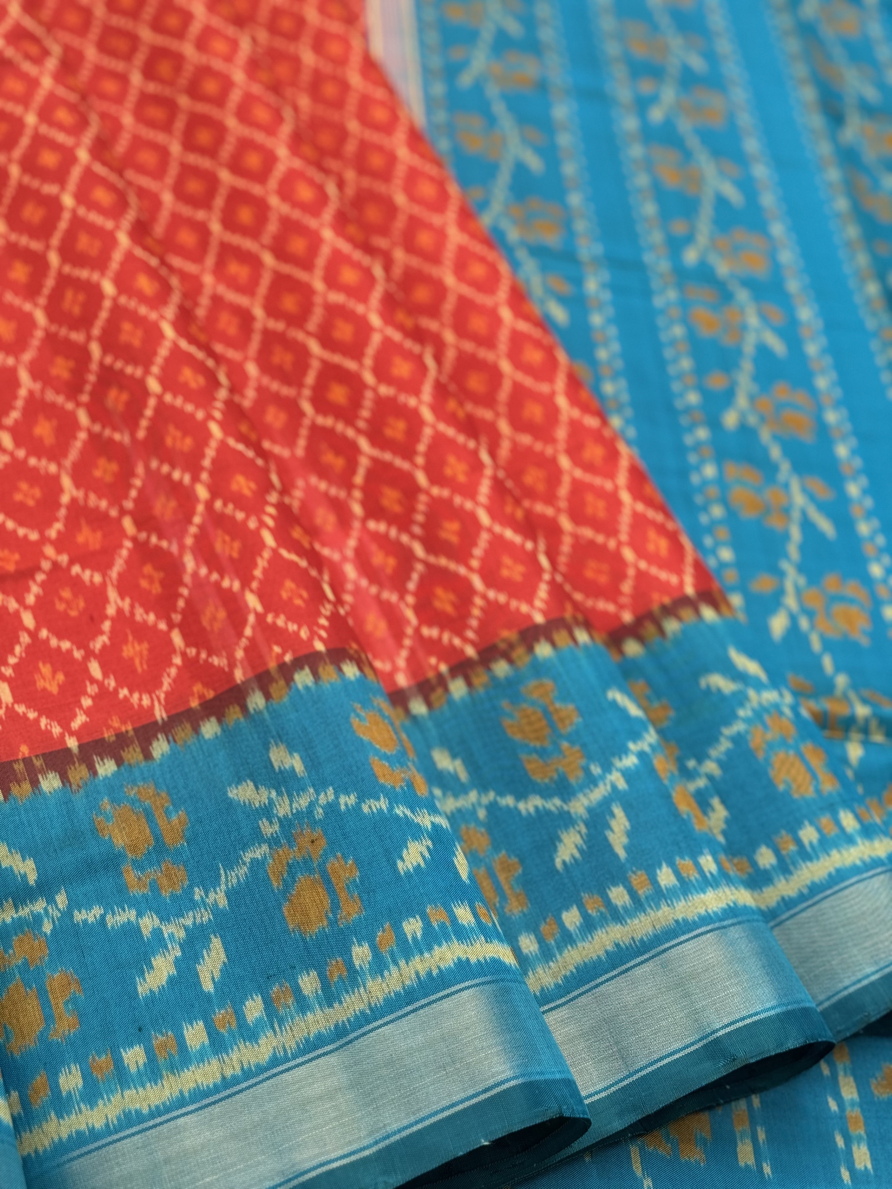 A gorgeous burnt Orange with teal single ikkat patola silk saree