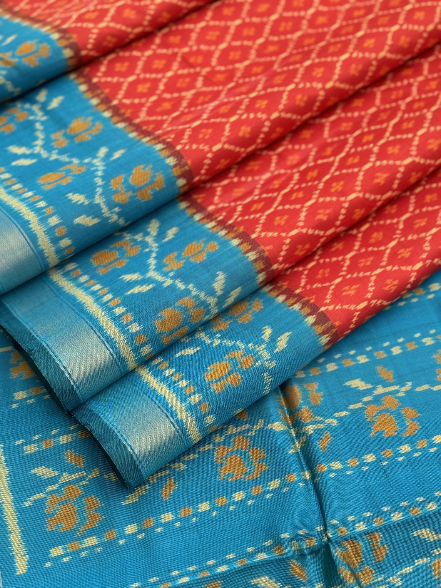 A gorgeous burnt Orange with teal single ikkat patola silk saree