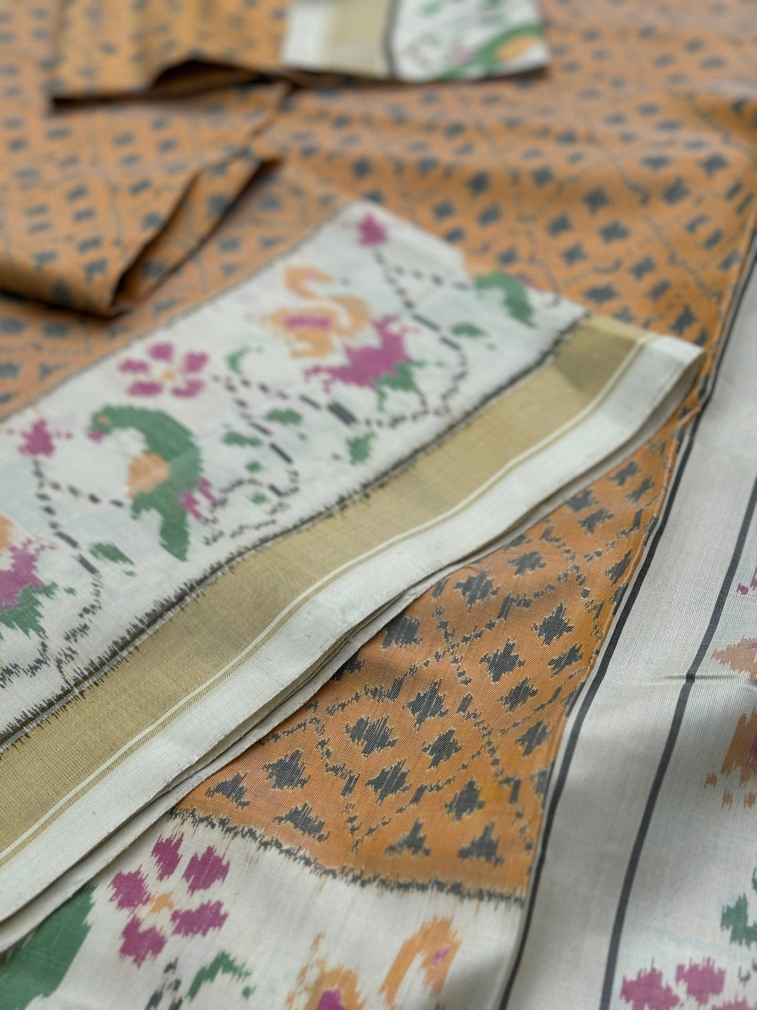 A gorgeous muted gold with offwhite single ikkat patola silk SAREE