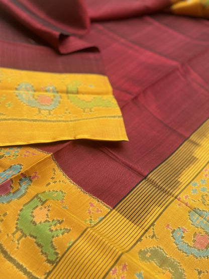 A gorgeous mustard yellow with burgundy single ikkat patola silk SAREE with parrot and peacock motifs