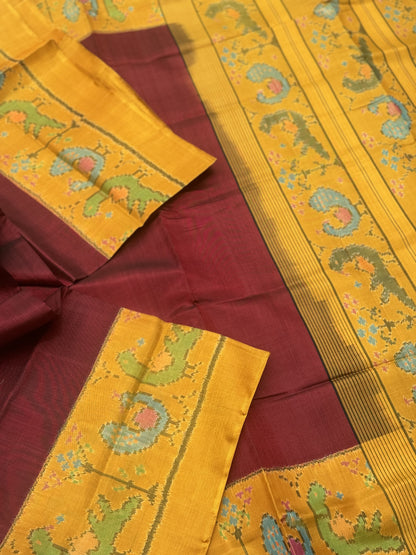 A gorgeous mustard yellow with burgundy single ikkat patola silk SAREE with parrot and peacock motifs