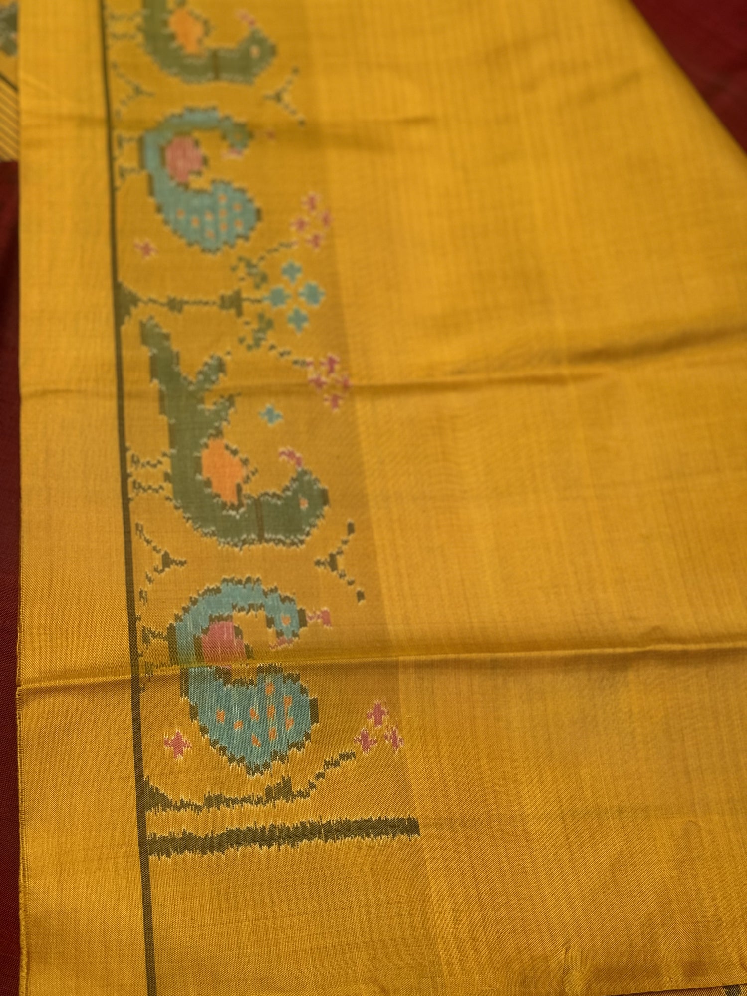 A gorgeous mustard yellow with burgundy single ikkat patola silk SAREE with parrot and peacock motifs