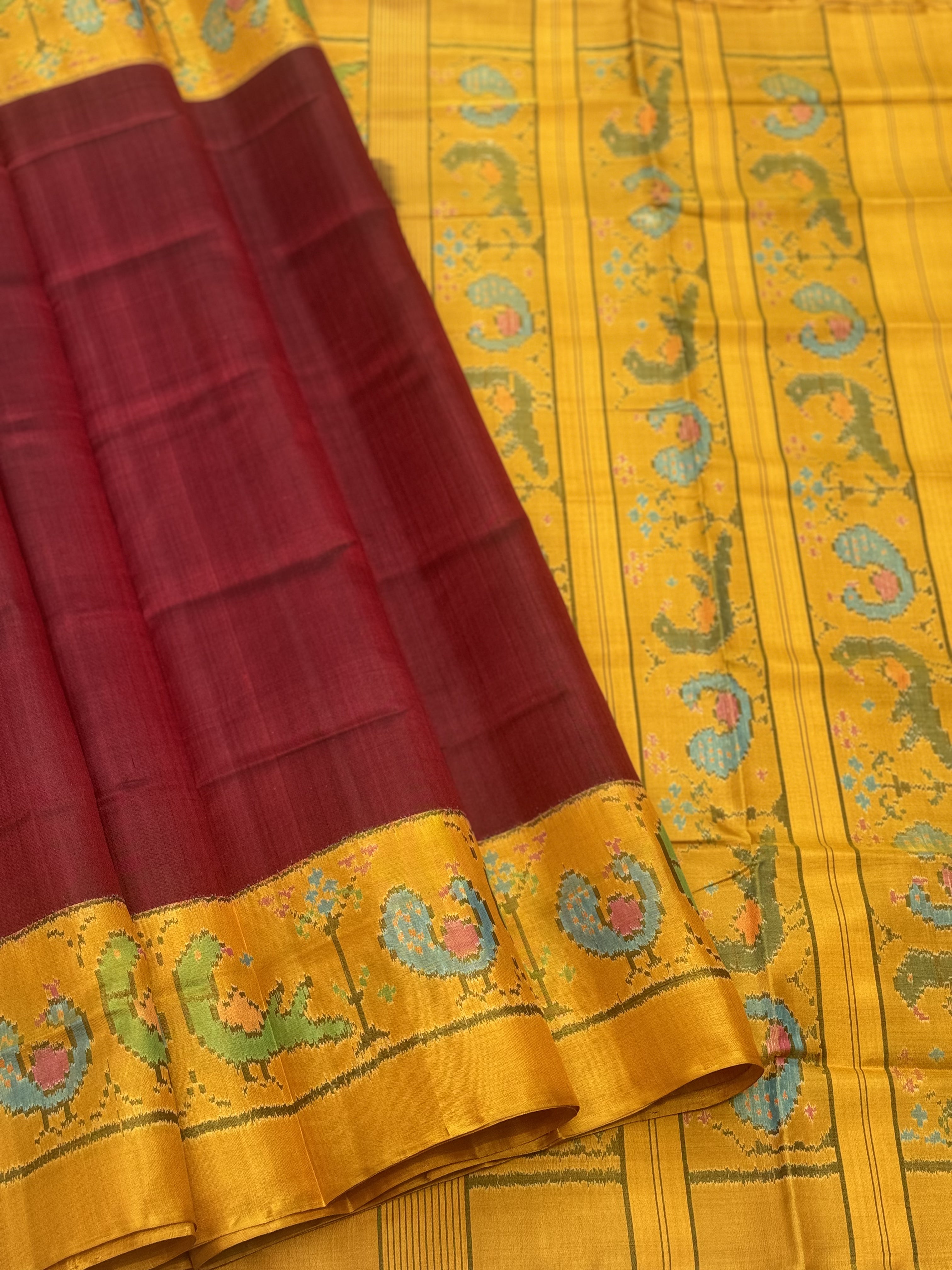 A gorgeous mustard yellow with burgundy single ikkat patola silk SAREE with parrot and peacock motifs