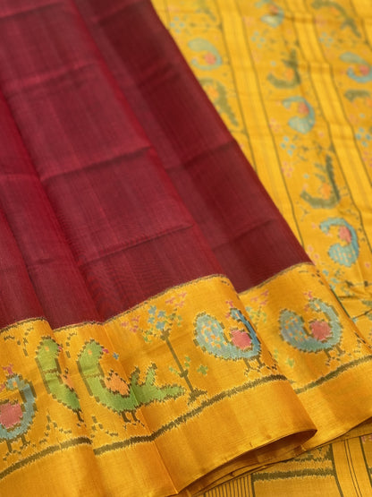 A gorgeous mustard yellow with burgundy single ikkat patola silk SAREE with parrot and peacock motifs