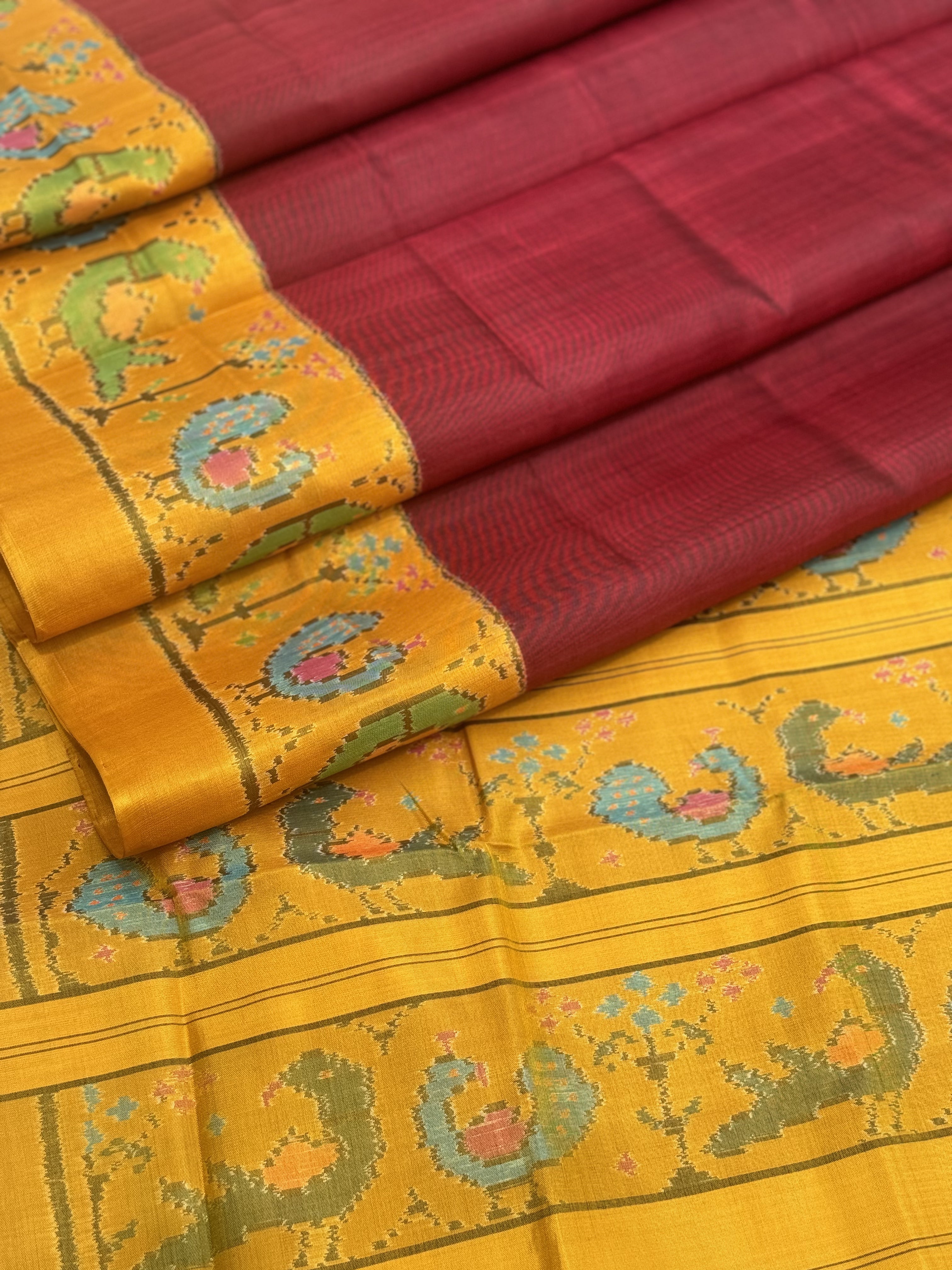 A gorgeous mustard yellow with burgundy single ikkat patola silk SAREE with parrot and peacock motifs