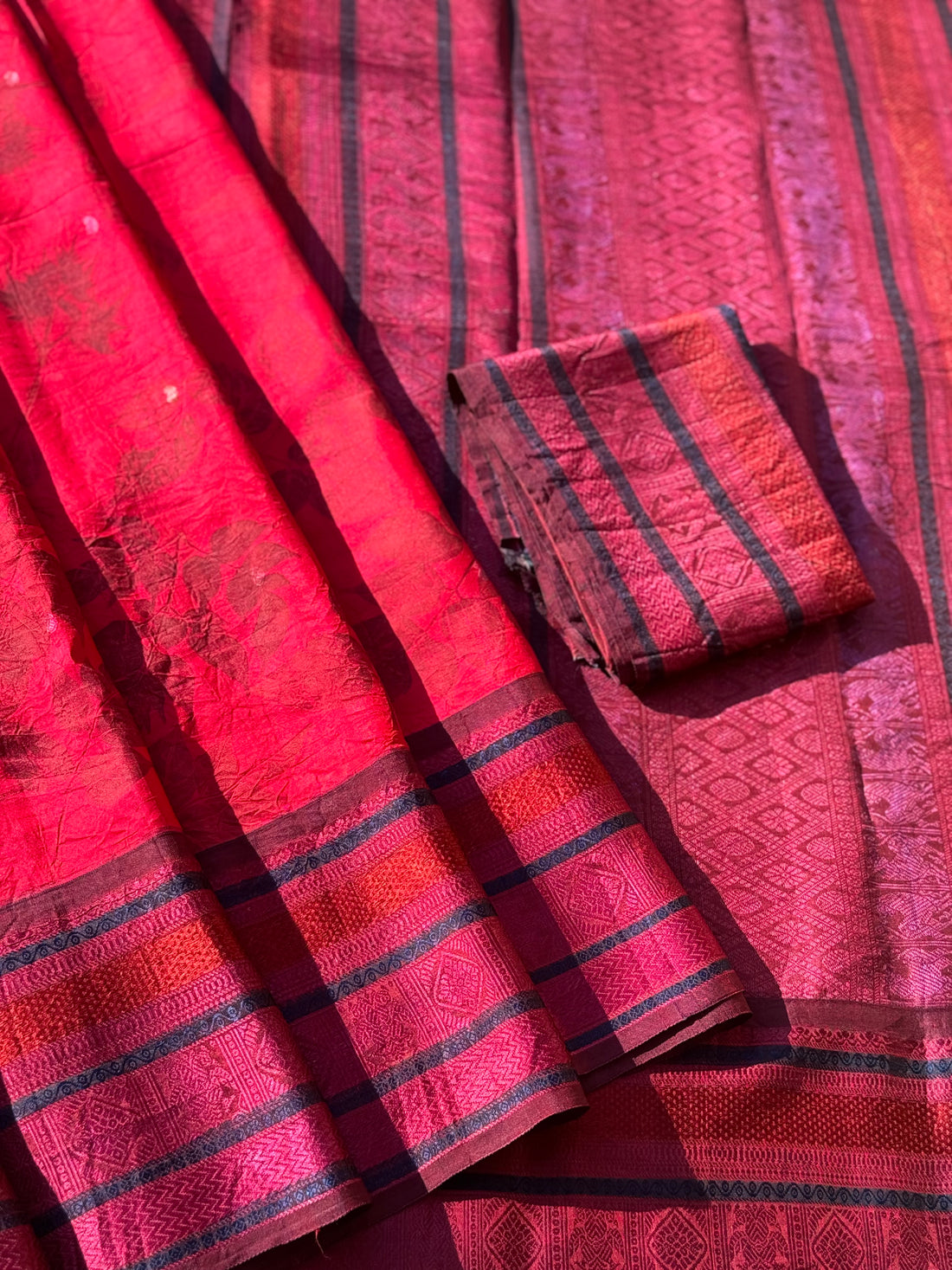 A stunningly gorgeous pinkish red threadwork kanchivaram silk saree with Ecoprints