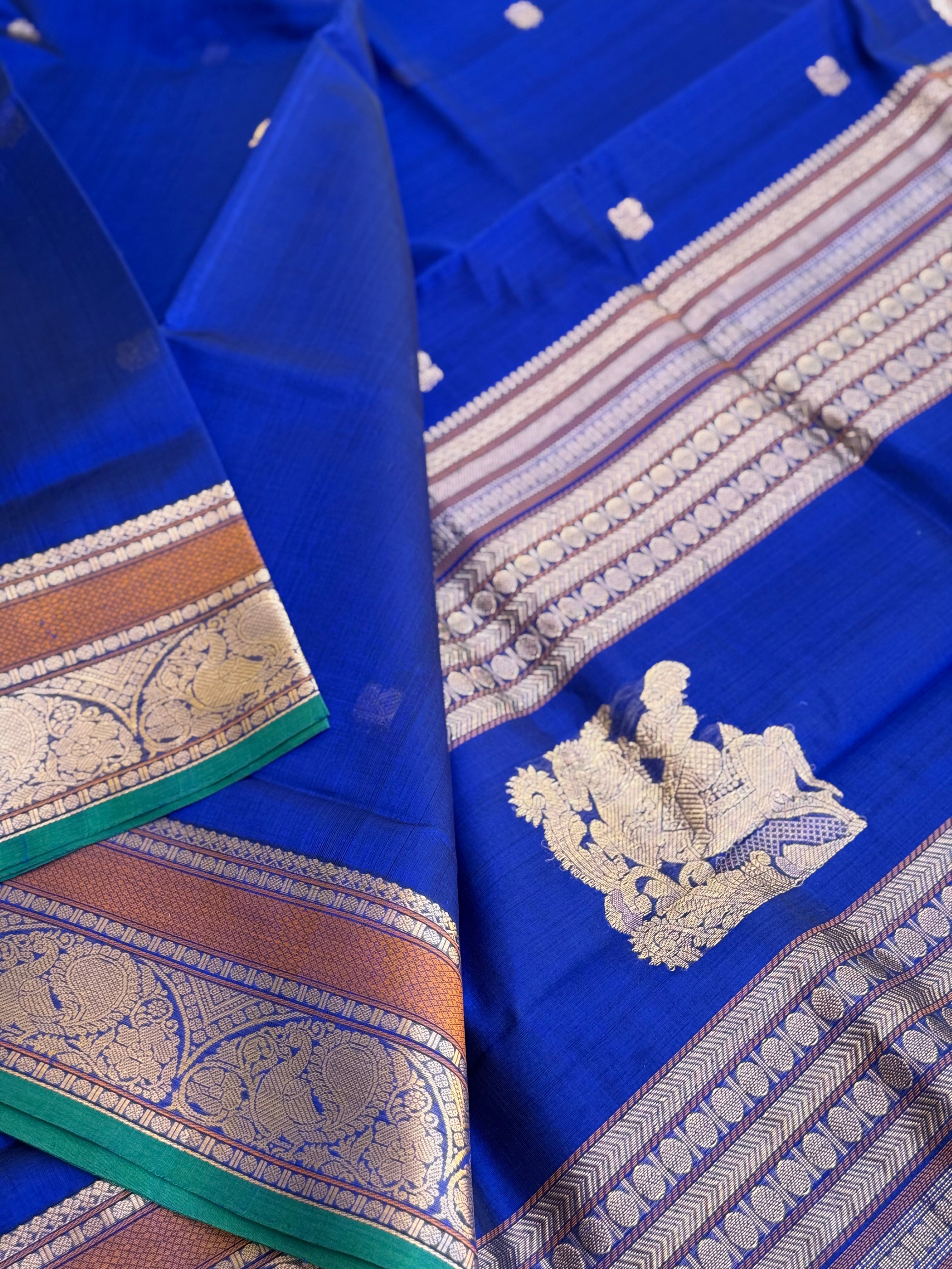 Ms blue Kanchi silk cotton saree with conia buttas