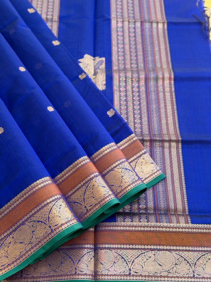 Ms blue Kanchi silk cotton saree with conia buttas