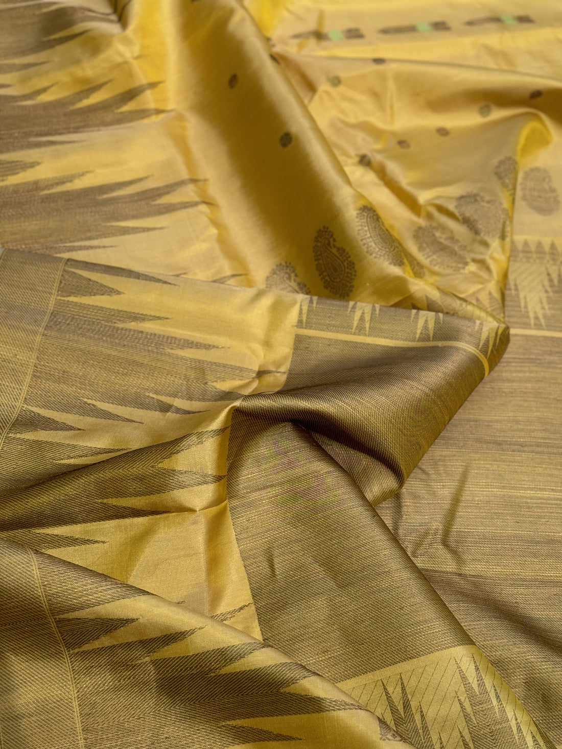 A gorgeous pastel yellow handwoven soft and lustrous temple woven gadwal silk saree