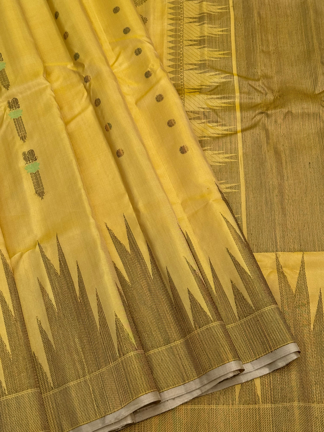 A gorgeous pastel yellow handwoven soft and lustrous temple woven gadwal silk saree