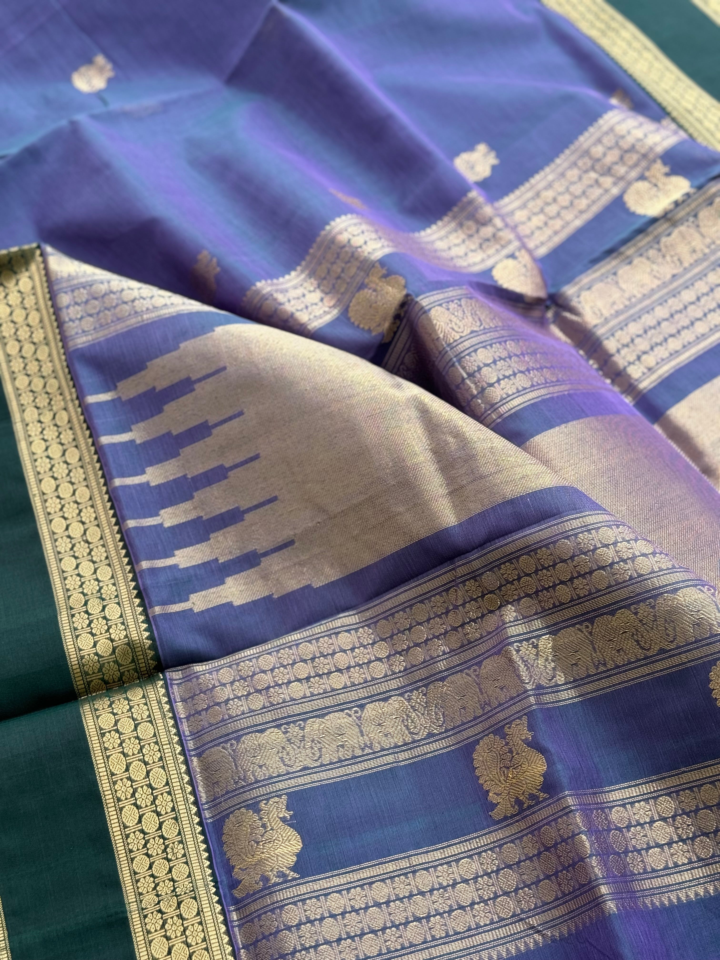 A gorgeous lavender with bottlegreen handwoven horsemotifs  Kanchi silk cotton saree