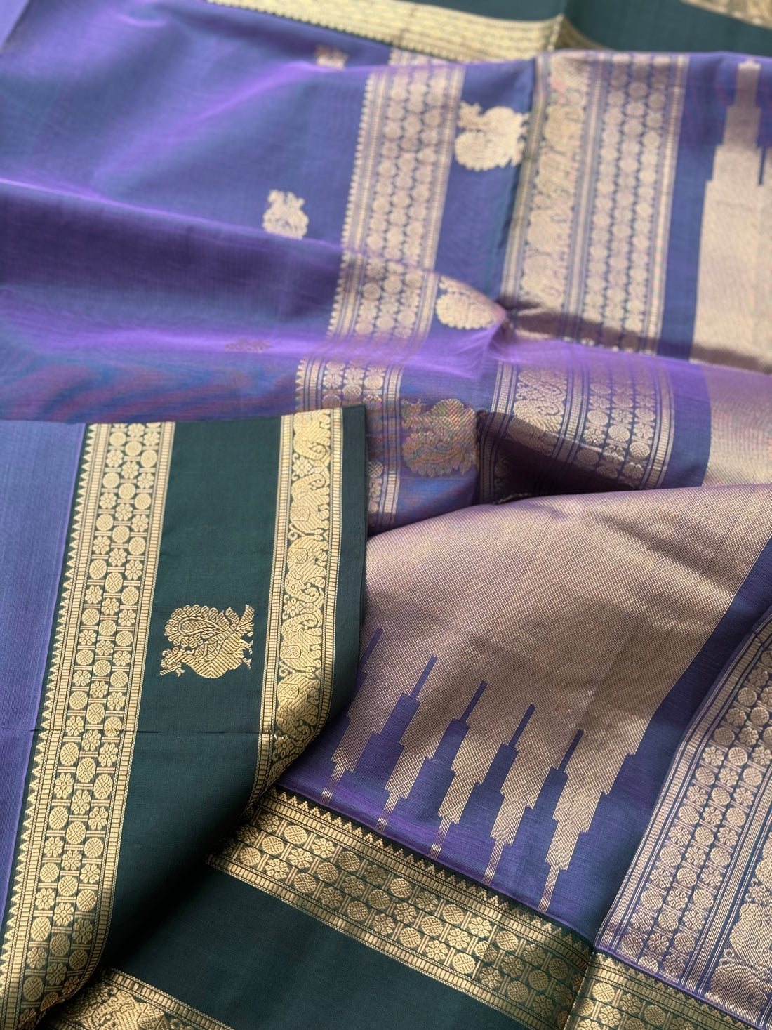 A gorgeous lavender with bottlegreen handwoven horsemotifs Kanchi silk cotton saree