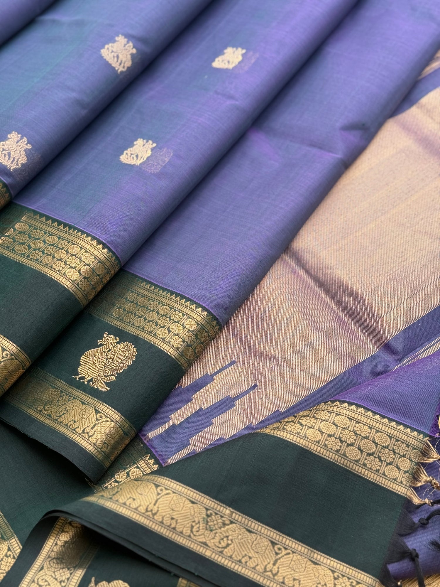 A gorgeous lavender with bottlegreen handwoven horsemotifs  Kanchi silk cotton saree