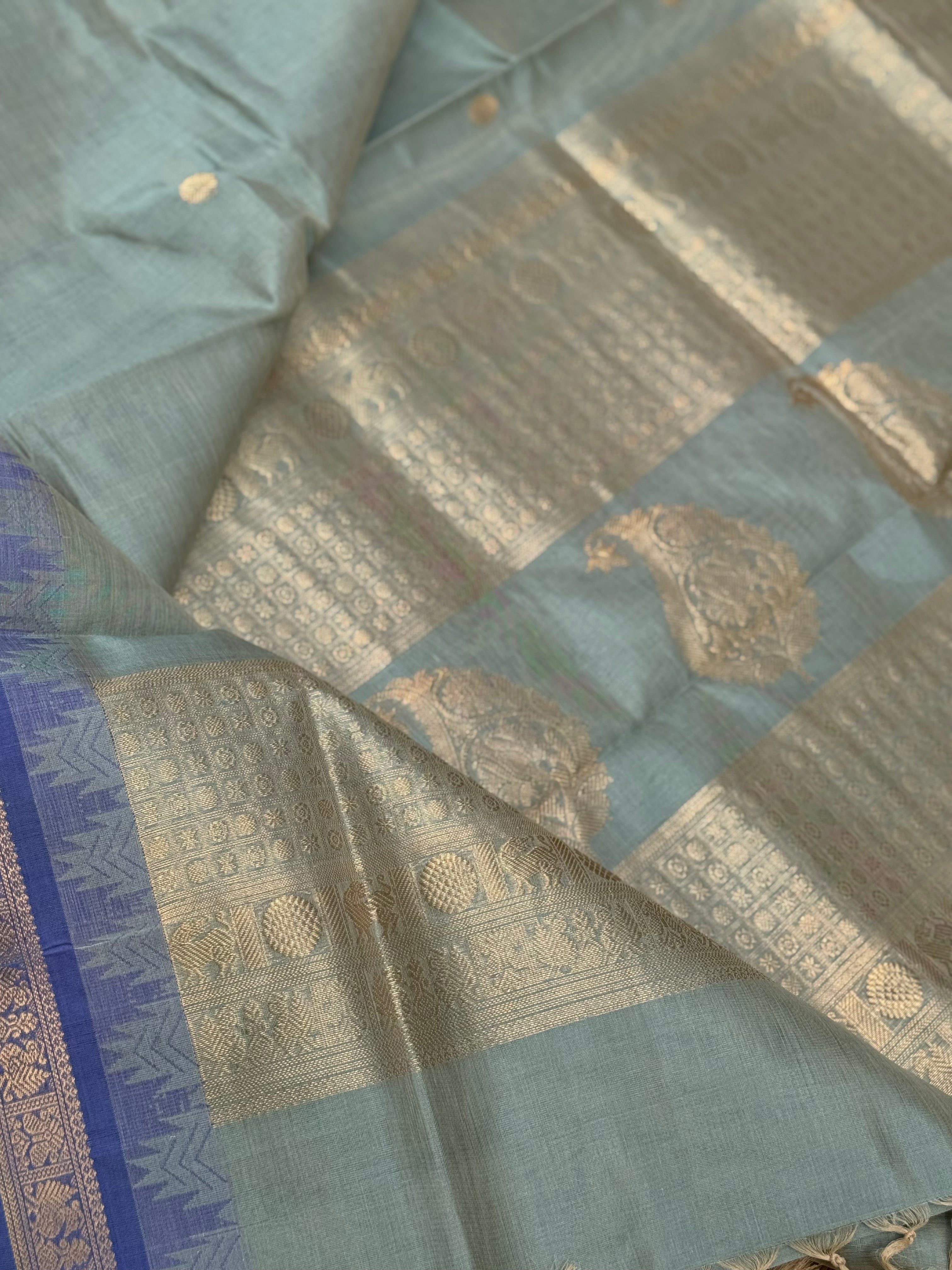 Kanchi silk cotton saree in sage green with blue shade zari woven