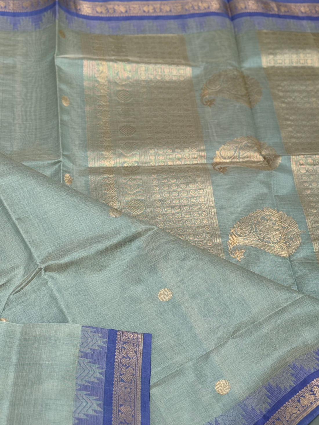 Kanchi silk cotton saree in sage green with blue shade zari woven