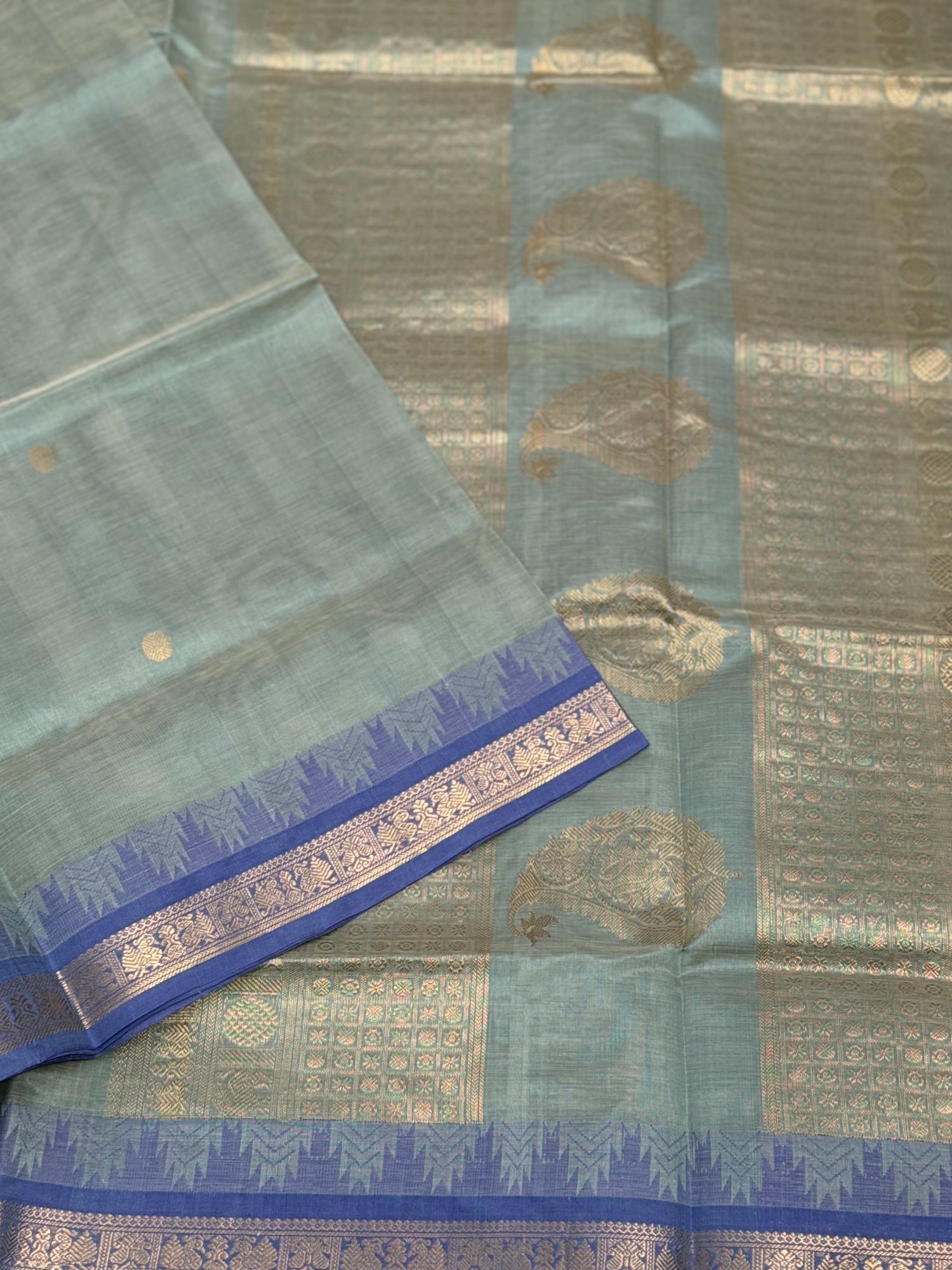 Kanchi silk cotton saree in sage green with blue shade zari woven