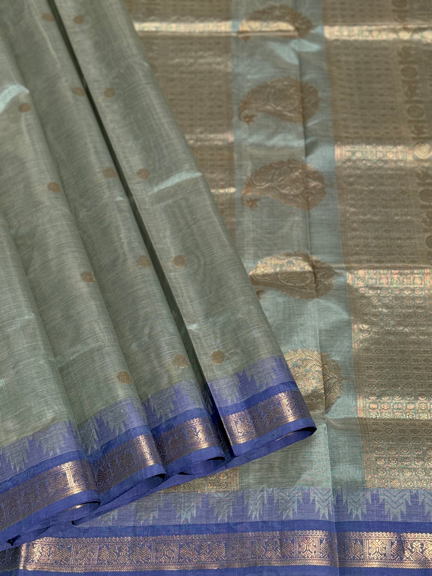 Kanchi silk cotton saree in sage green with blue shade zari woven