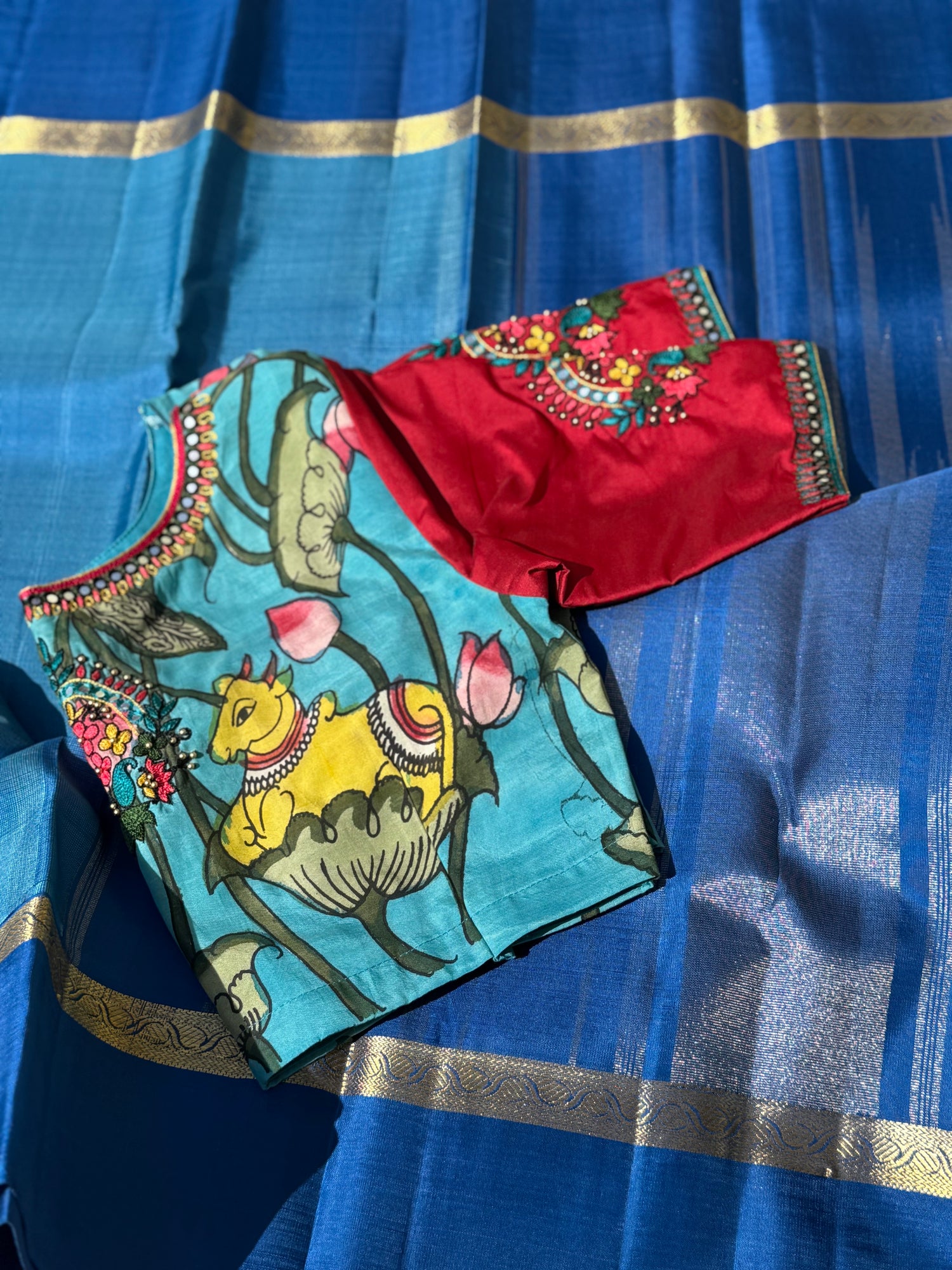 The classy peacock blue with red white silk penkalamkari blouse