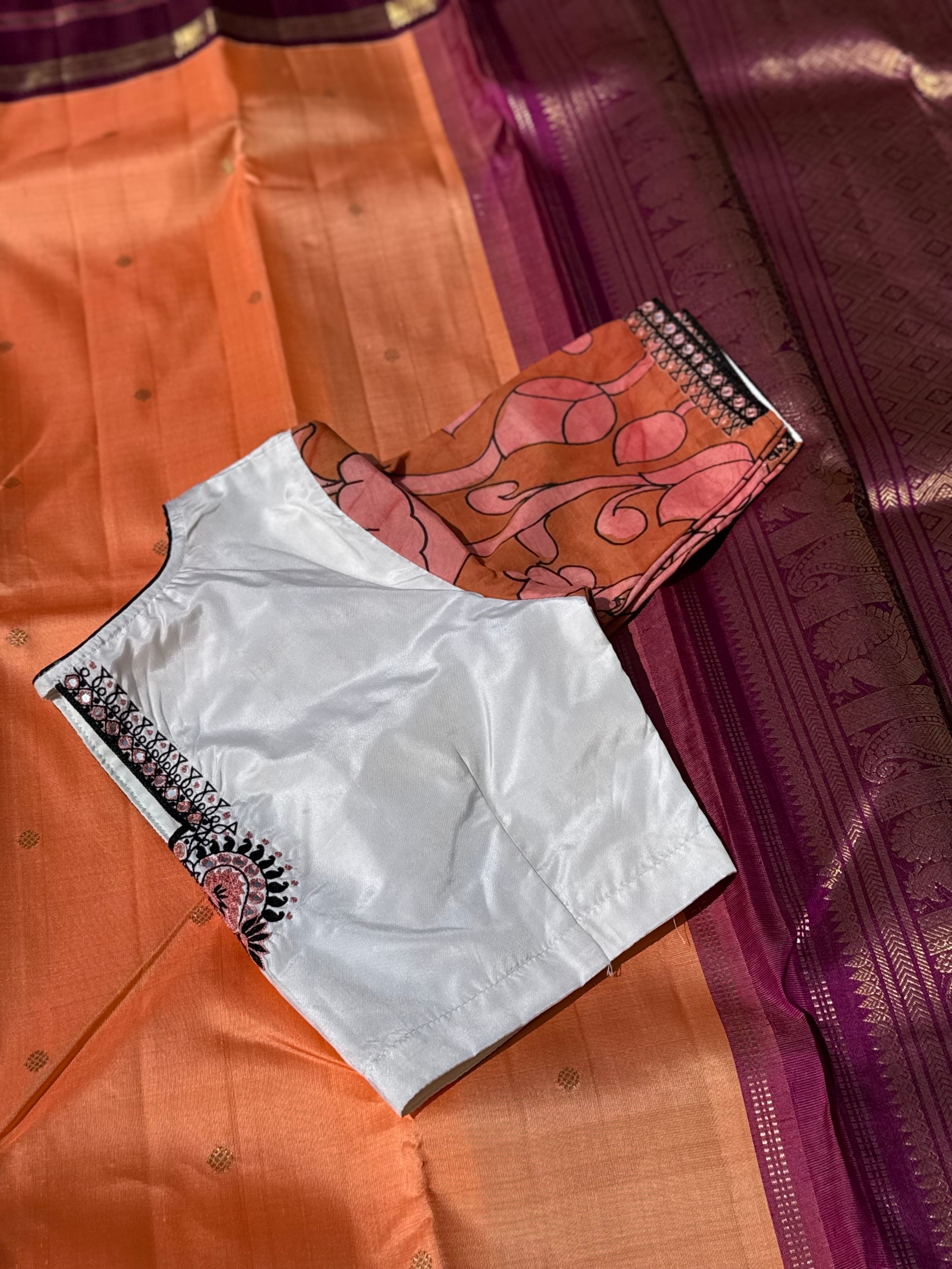 The contemporary style on peach orange with ivory white silk penkalamkari blouse