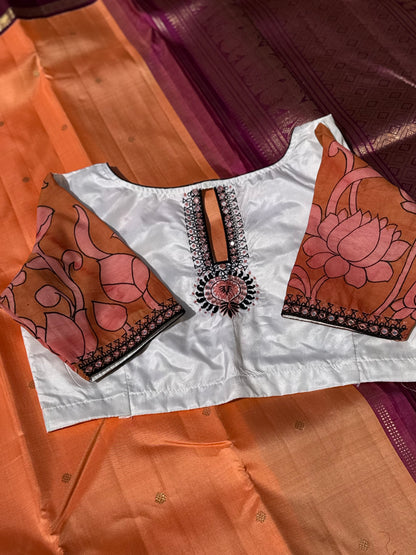 The contemporary style on peach orange with ivory white silk penkalamkari blouse