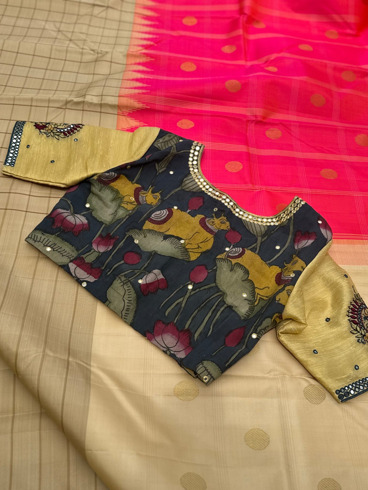 The raw silk tissue gold shade penkalamkari blouse with mirror embroidered work