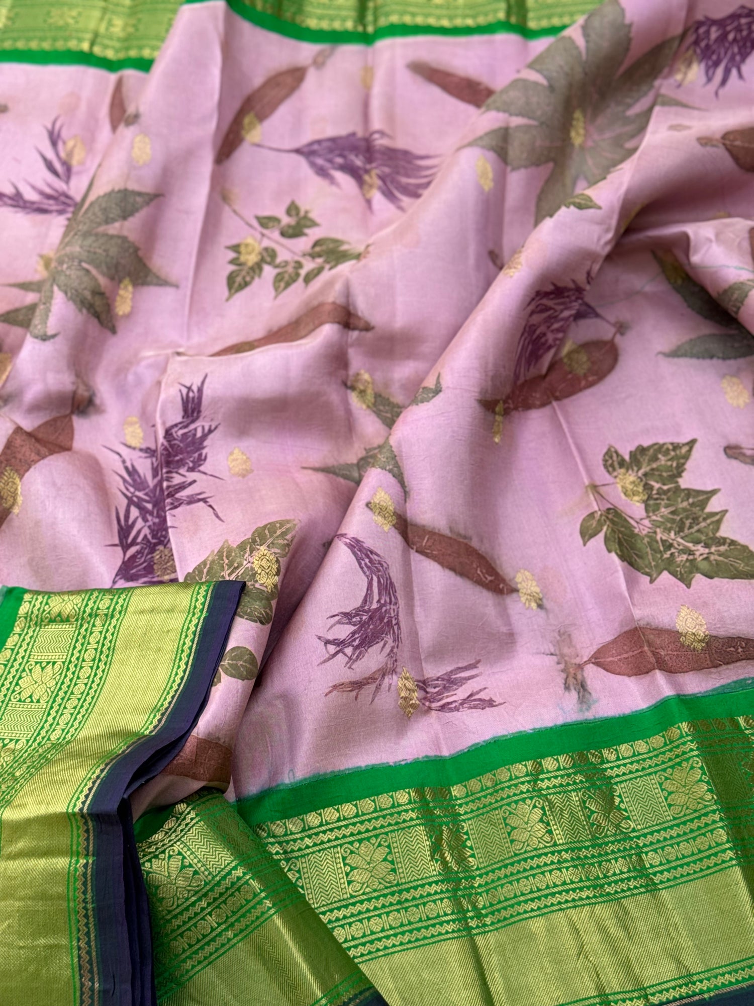 A gorgeous natural ecoprints done on mauve pink with green kuttu gadwal silk saree