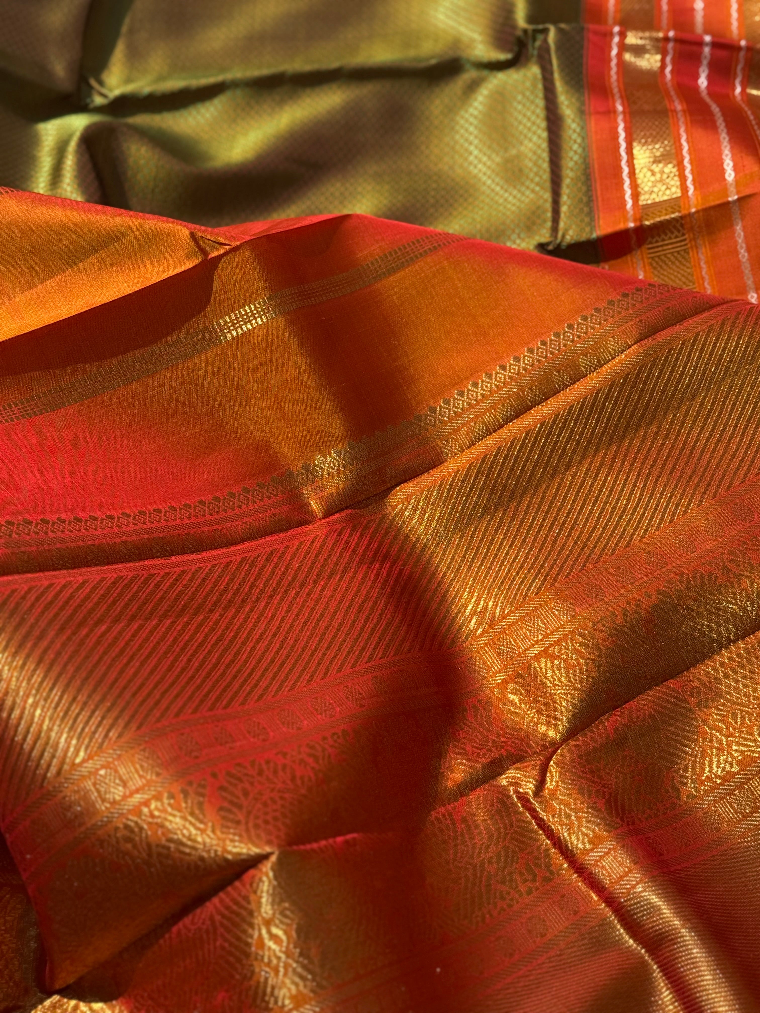 A Fern Green with orange masterpiece honeycomb motif korvai kanchivaram silk saree