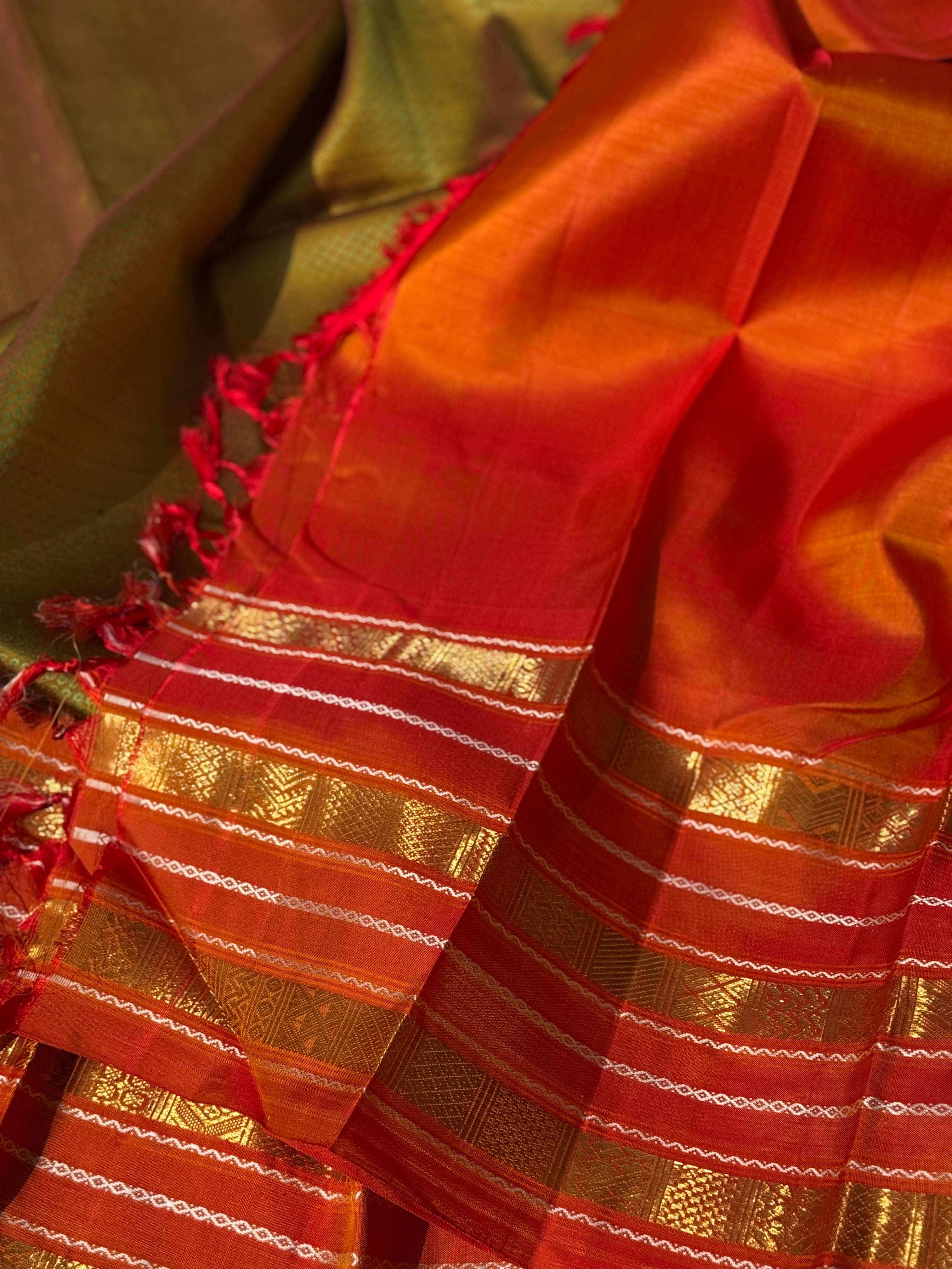 A Fern Green with orange masterpiece honeycomb motif korvai kanchivaram silk saree