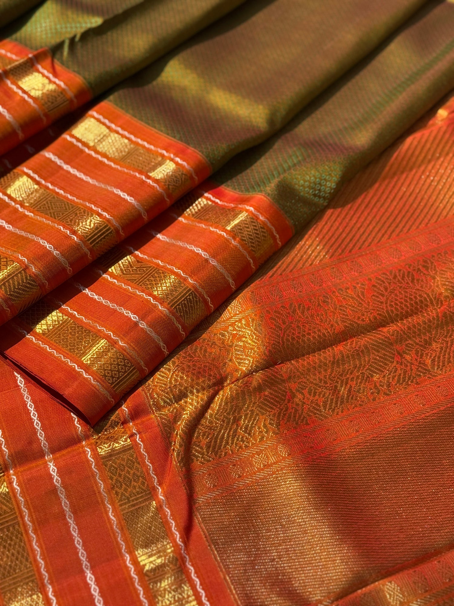 A Fern Green with orange masterpiece honeycomb motif korvai kanchivaram silk saree