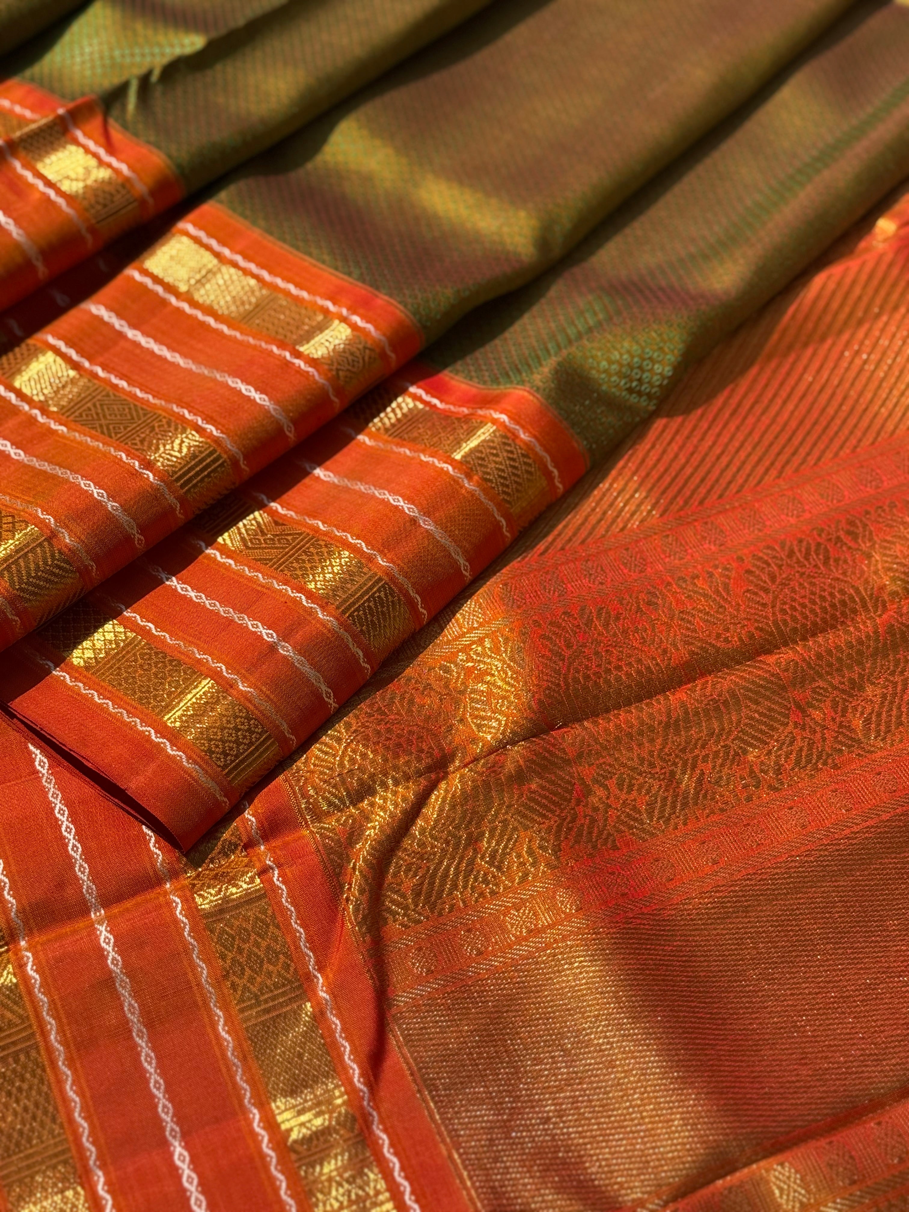 A Fern Green with orange masterpiece honeycomb motif korvai kanchivaram silk saree