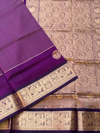 A gorgeous purple shade handwoven Oosi zari checks kanchi silk cotton saree