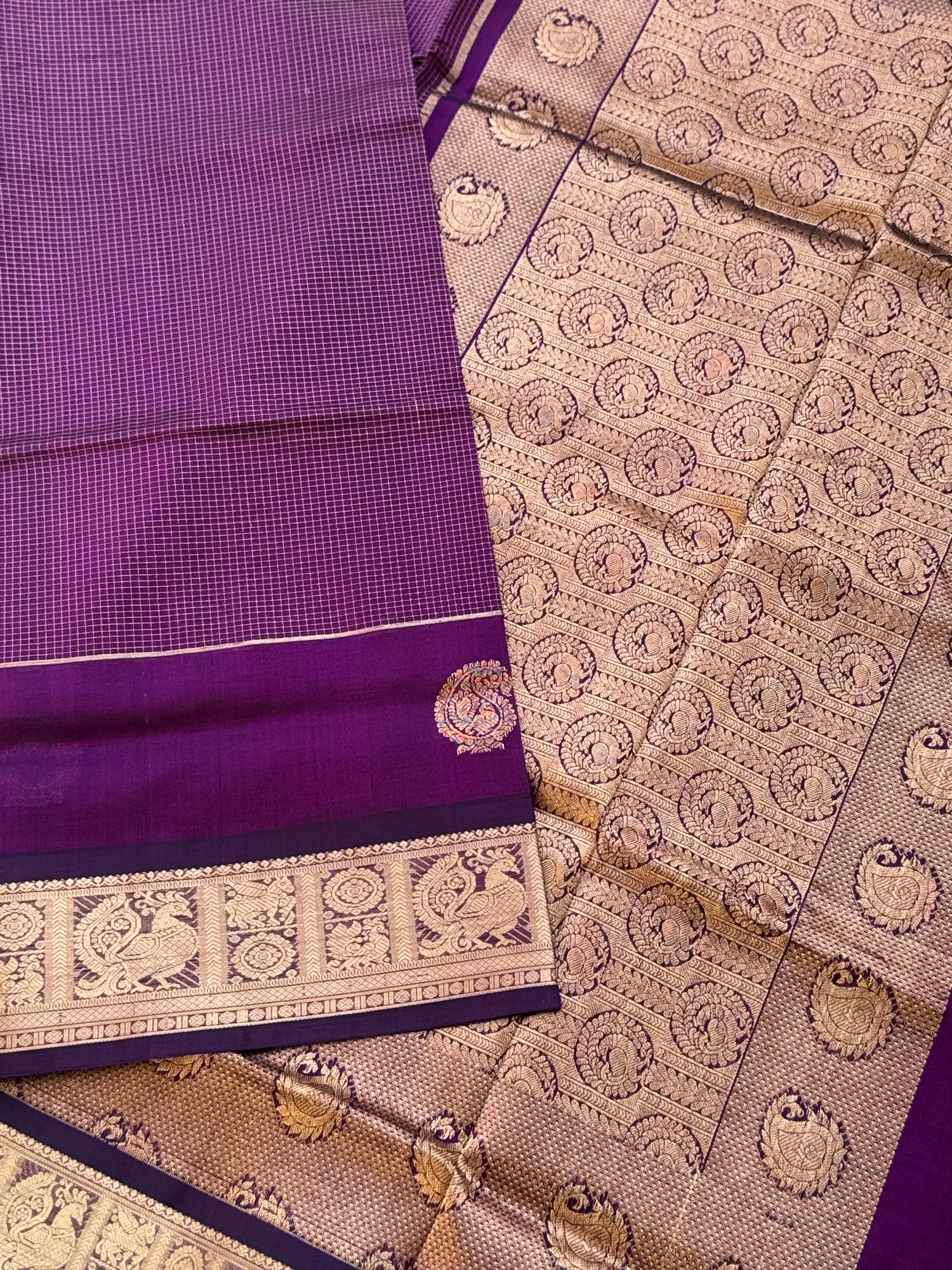 A gorgeous purple shade handwoven Oosi zari checks kanchi silk cotton saree