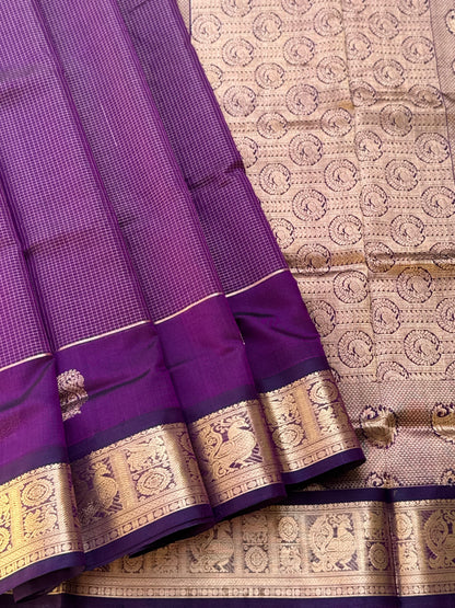 A gorgeous purple shade handwoven Oosi zari checks kanchi silk cotton saree