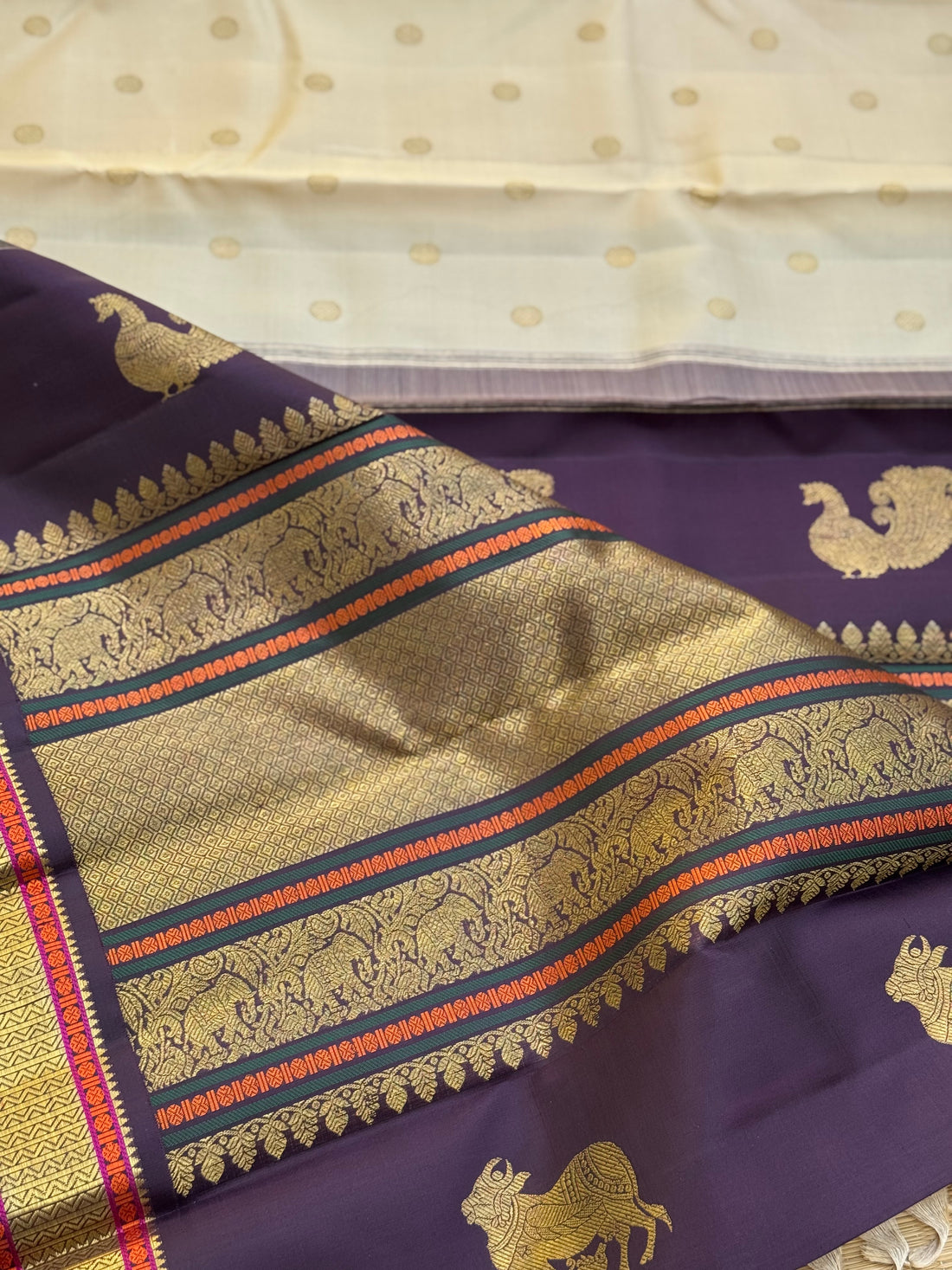An elegant ivory with betel nut shade korvai kanchivaram silk saree with kamalam motifs