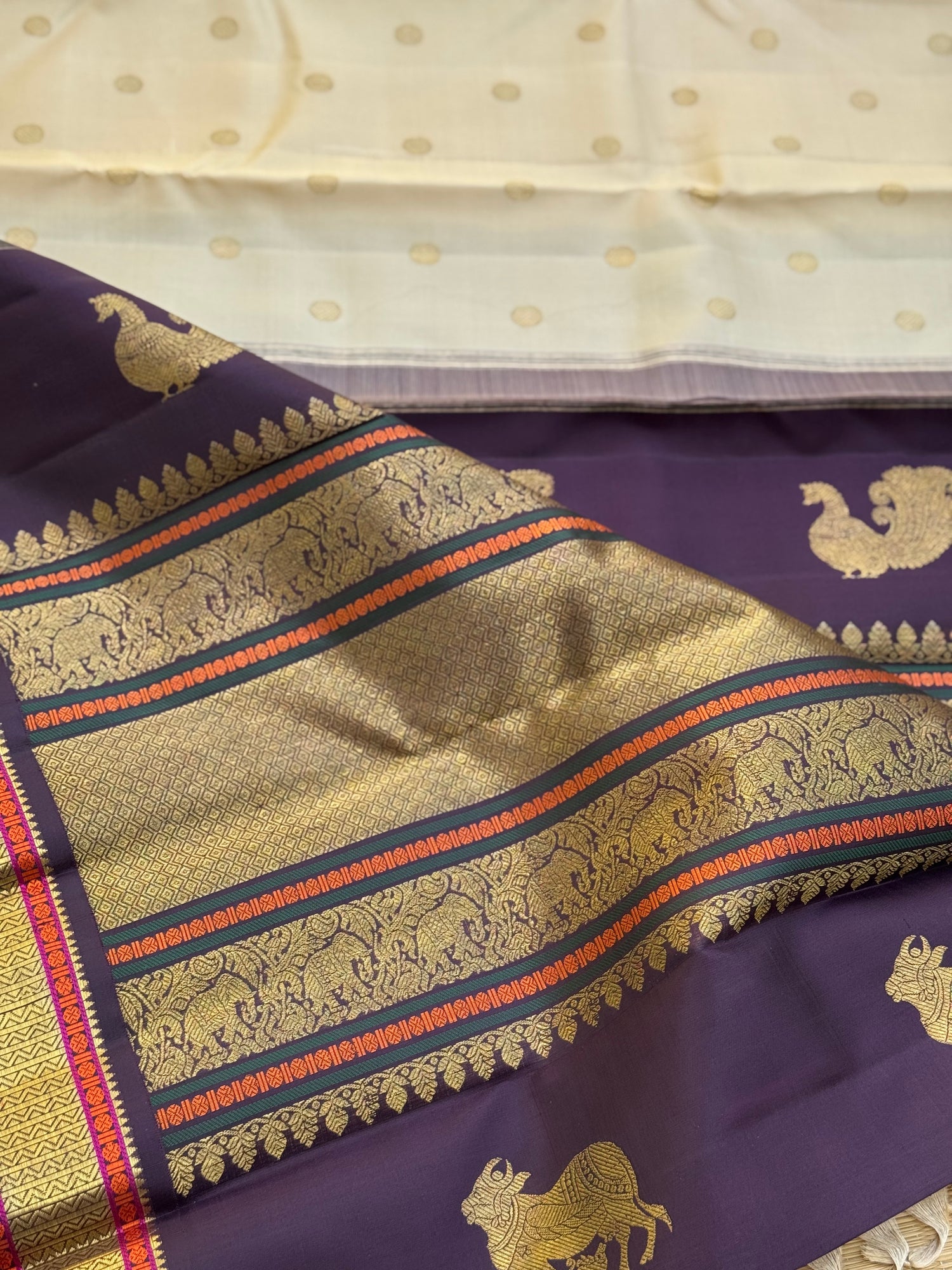 An elegant ivory with betel nut shade korvai kanchivaram silk saree with kamalam motifs