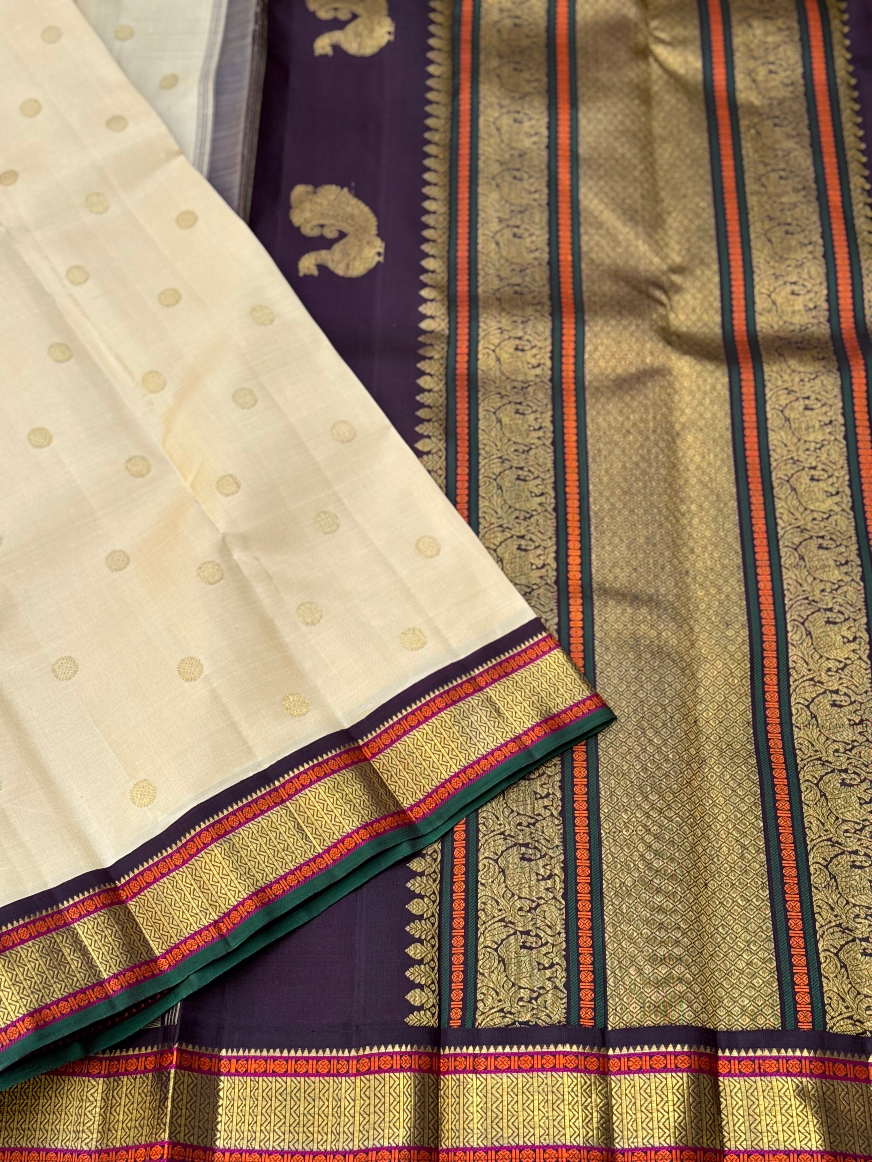 An elegant ivory with betel nut shade korvai kanchivaram silk saree with kamalam motifs