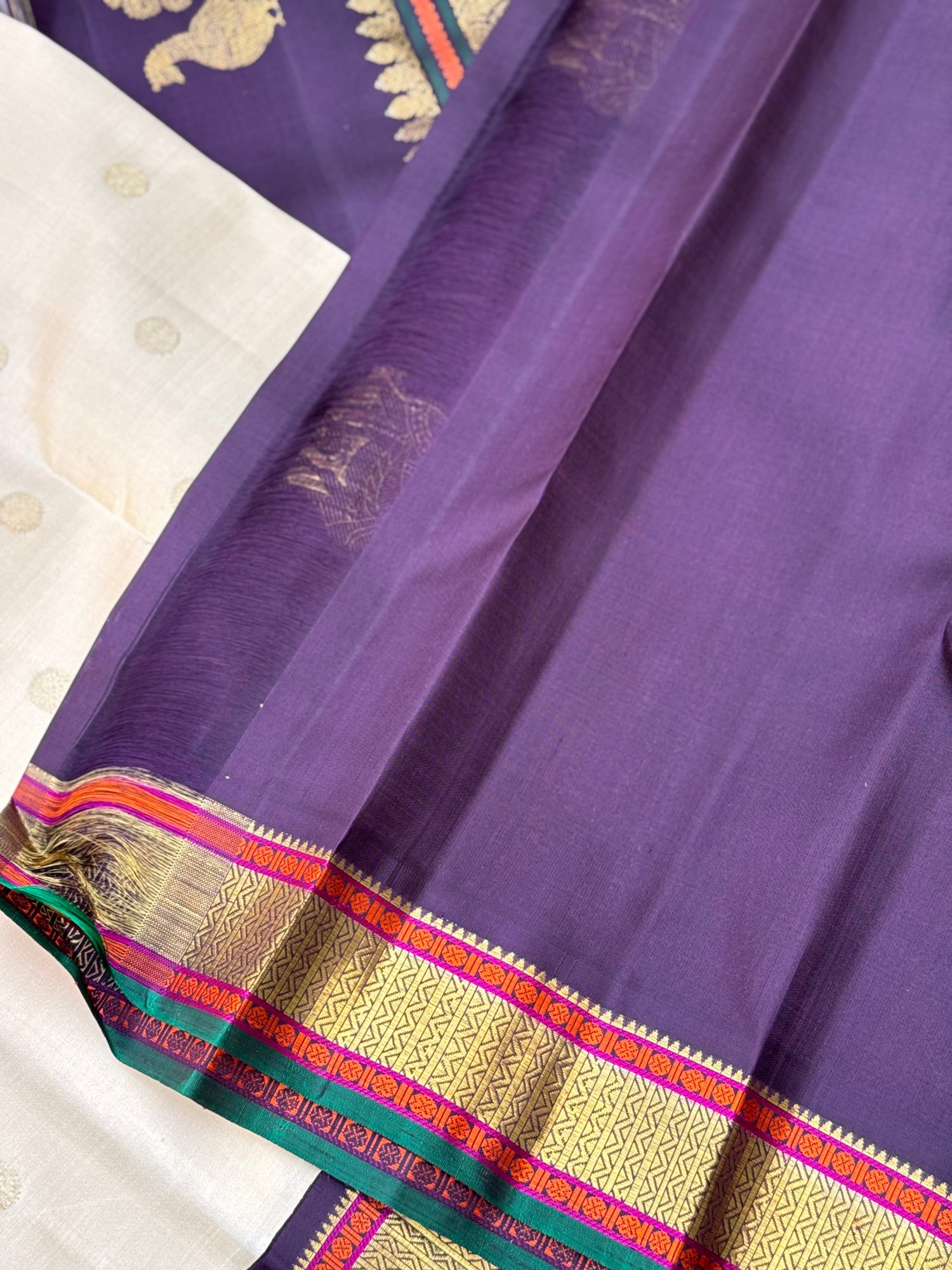 An elegant ivory with betel nut shade korvai kanchivaram silk saree with kamalam motifs
