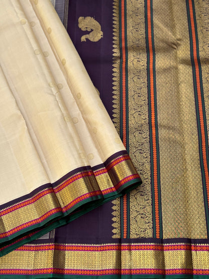An elegant ivory with betel nut shade korvai kanchivaram silk saree with kamalam motifs