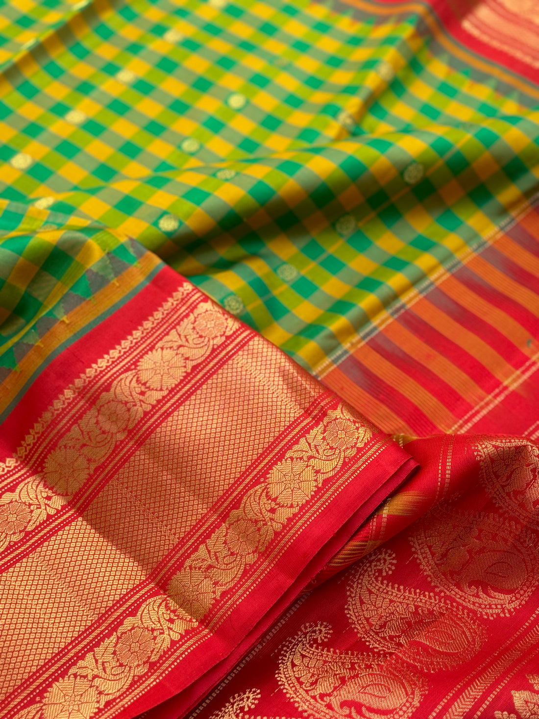 An Elegant yellow with green checks Gadwal silk saree