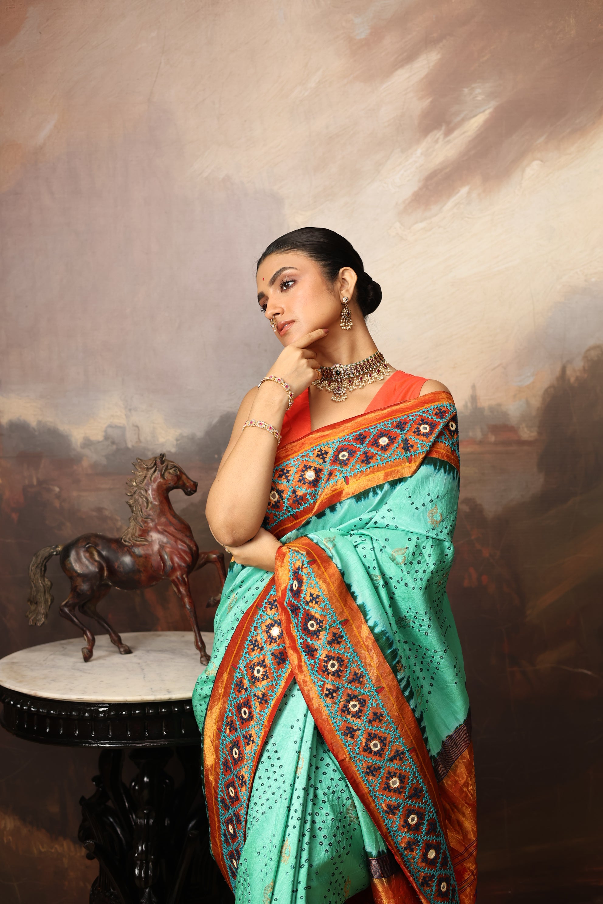 Intricate art piece blending Paithani Muniya with hand-knotted Bhandej and embellished with Kutch mirror work border