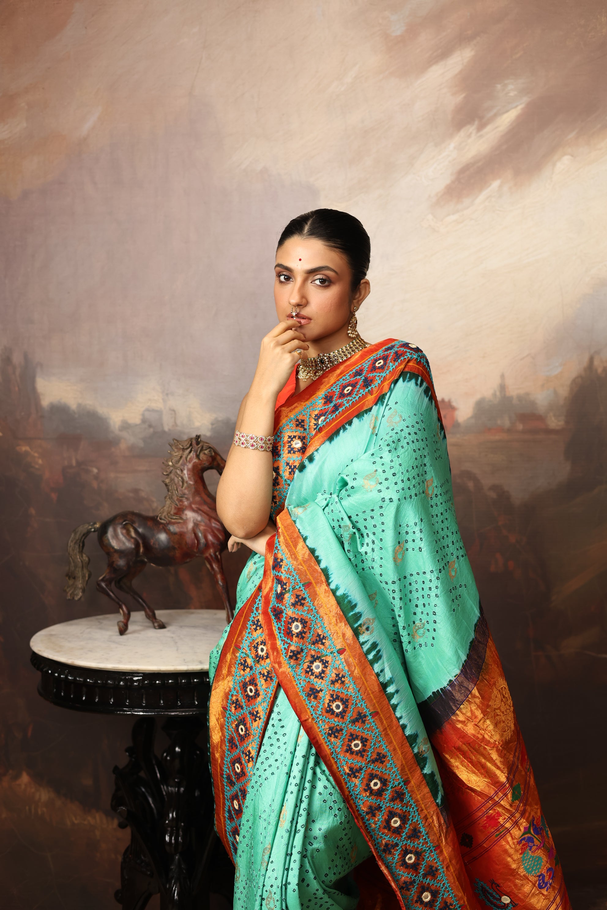 Intricate art piece blending Paithani Muniya with hand-knotted Bhandej and embellished with Kutch mirror work border