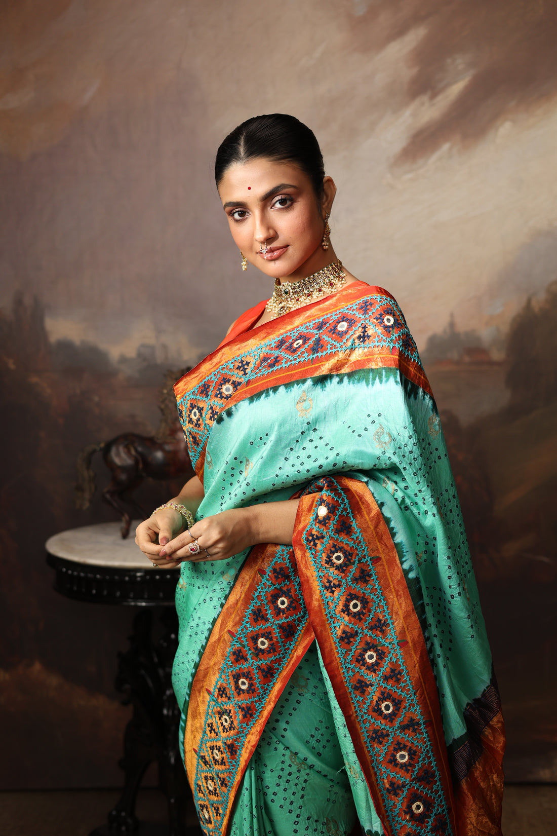 Intricate art piece blending Paithani Muniya with hand-knotted Bhandej and embellished with Kutch mirror work border