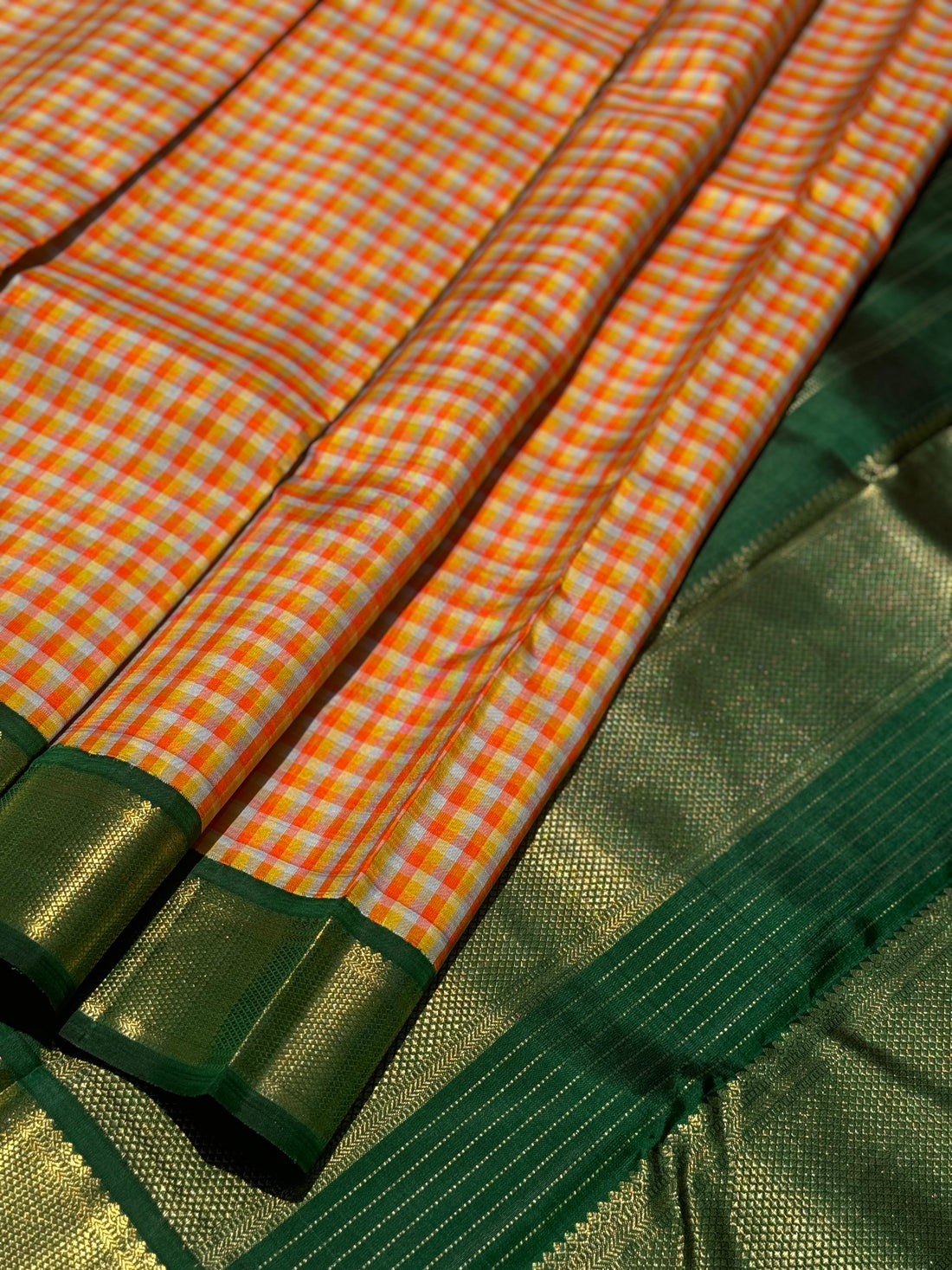 The stunner pastel orange and yellow checks with green shade korvai kanchivaram silk saree
