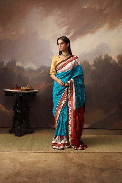Gorgeous lotus ikkat silk saree with teal peacock blue Bhandej and  Parsi gara hand embroidery