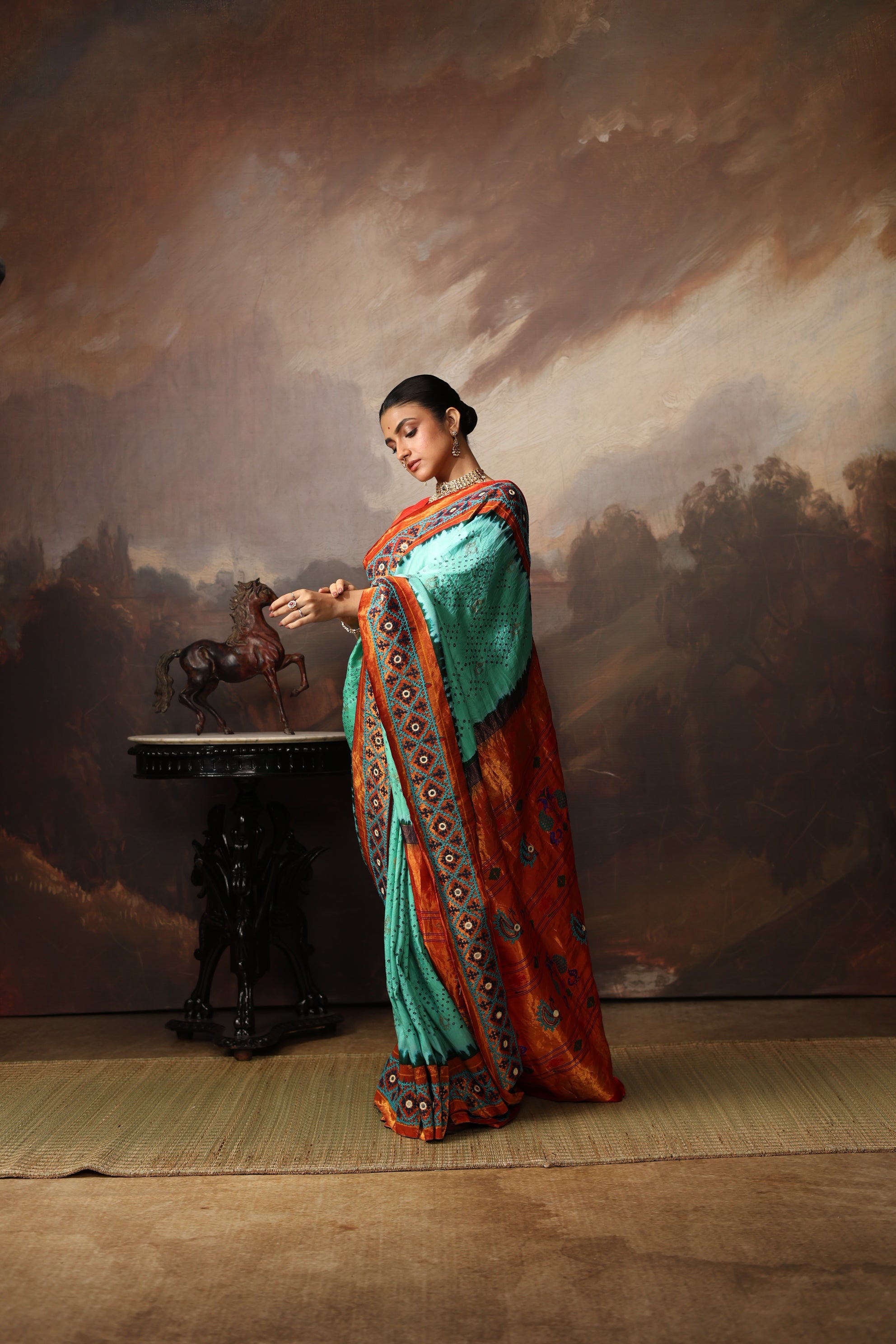 Intricate art piece blending Paithani Muniya with hand-knotted Bhandej and embellished with Kutch mirror work border