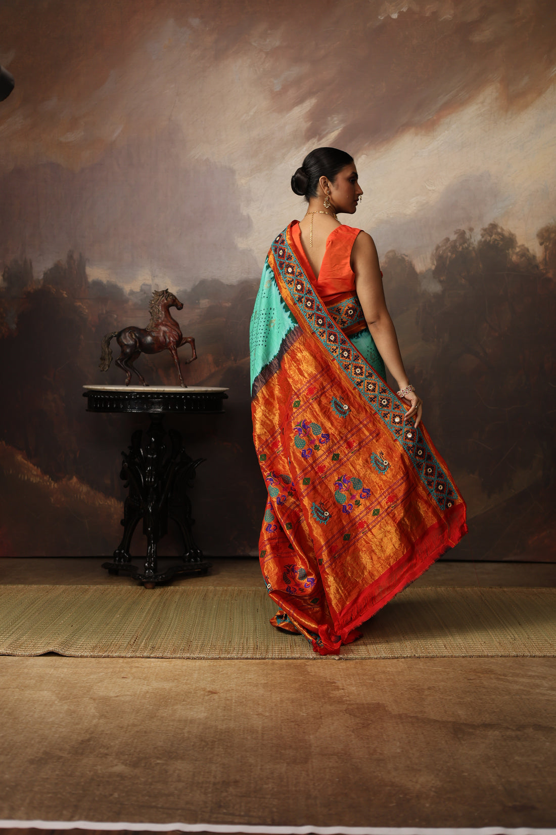 Intricate art piece blending Paithani Muniya with hand-knotted Bhandej and embellished with Kutch mirror work border