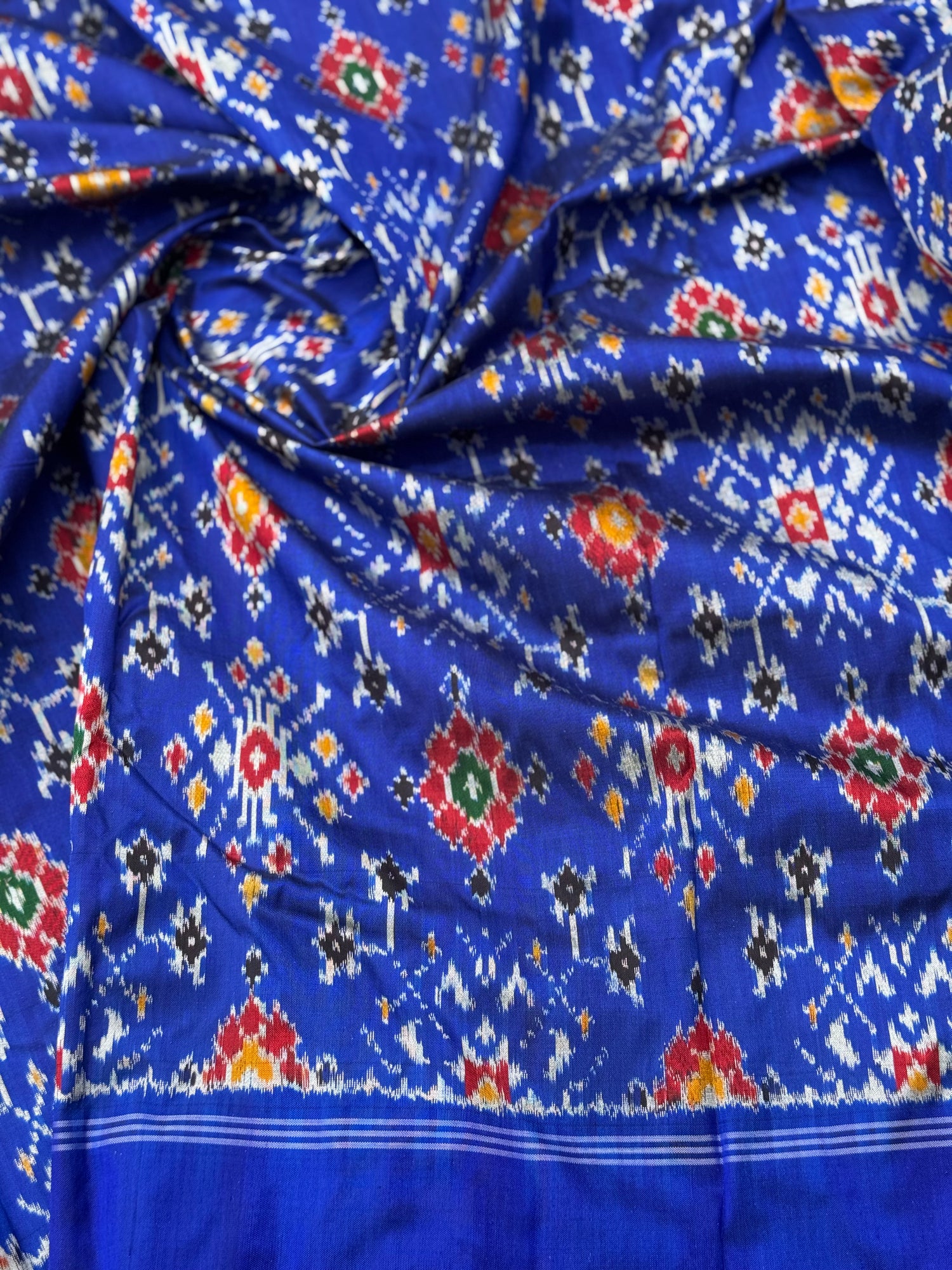 Blue patola inspired navratan ikkat design on pure mulberry silk fabric