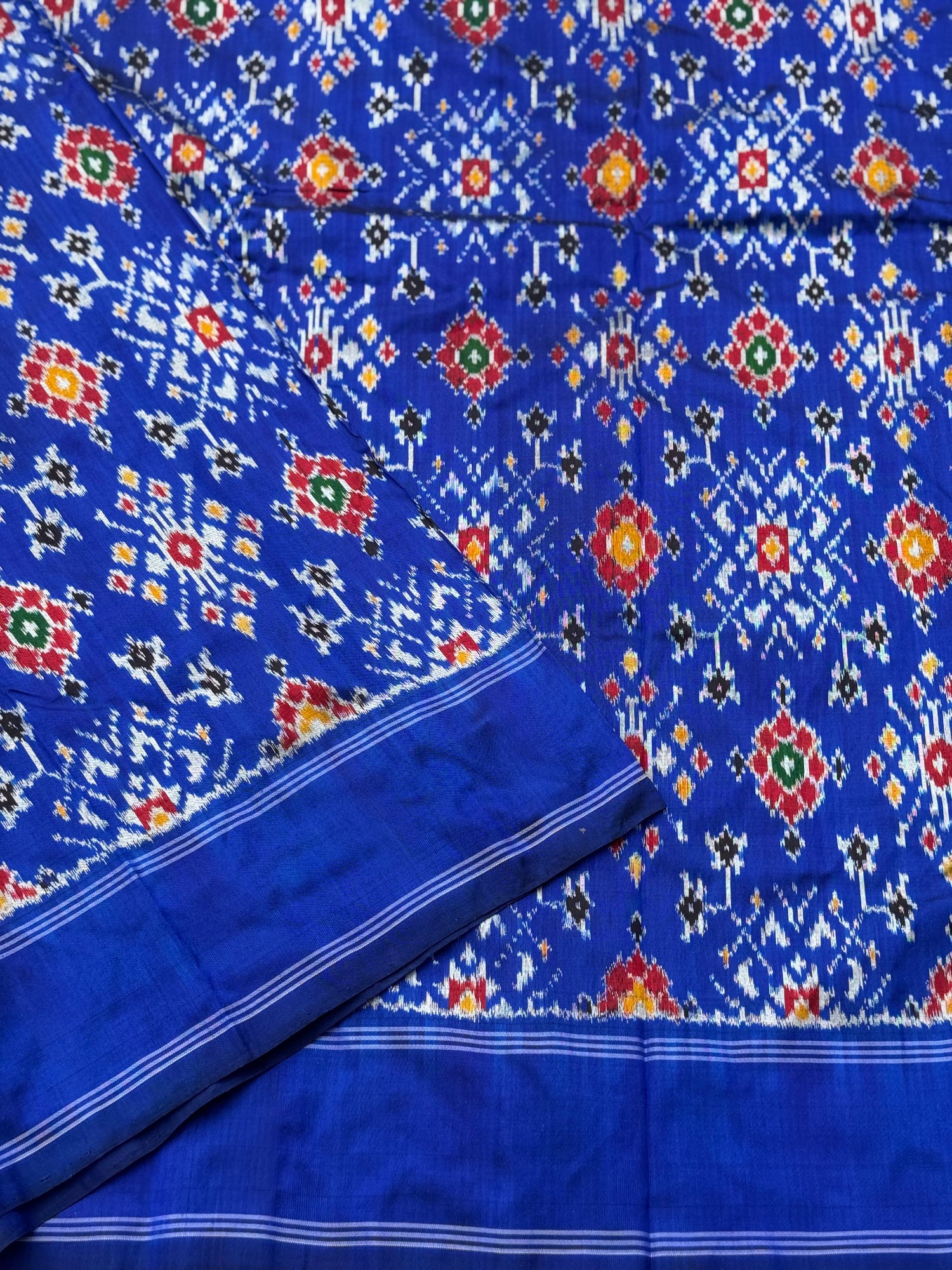 Blue patola inspired navratan ikkat design on pure mulberry silk fabric